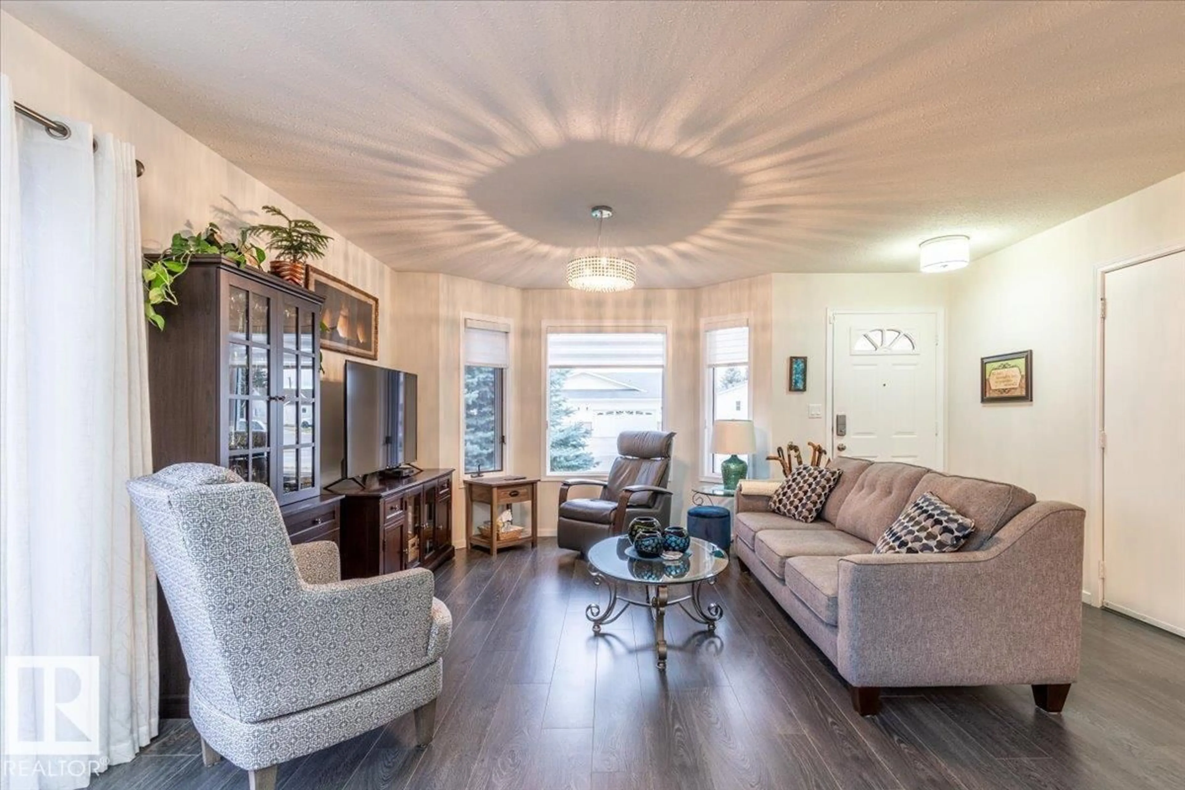 Living room with furniture, wood/laminate floor for 16 4410 52 AV, Wetaskiwin Alberta T9A3L9