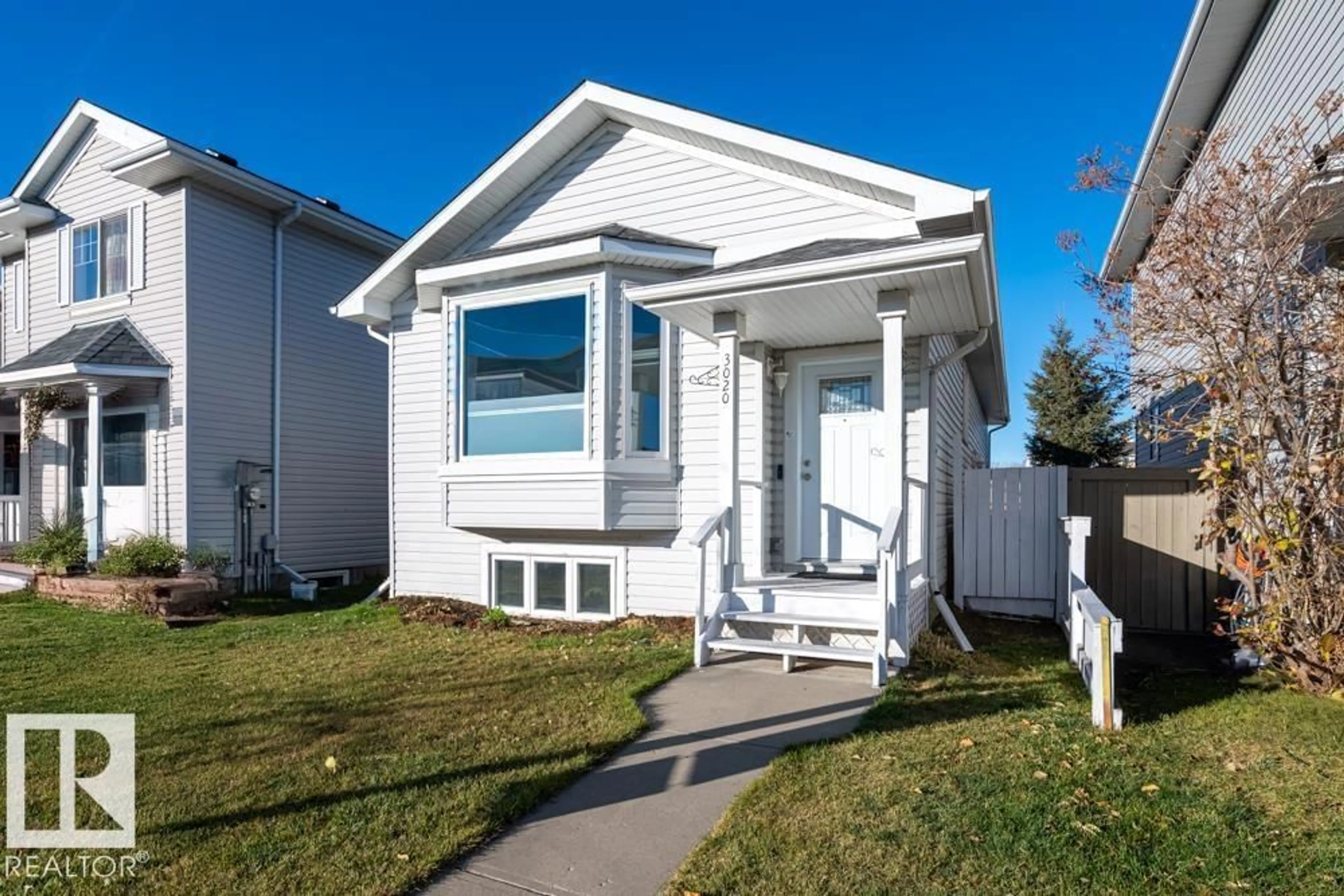 Home with vinyl exterior material, street for 3020 32 AV, Edmonton Alberta T6T1X1