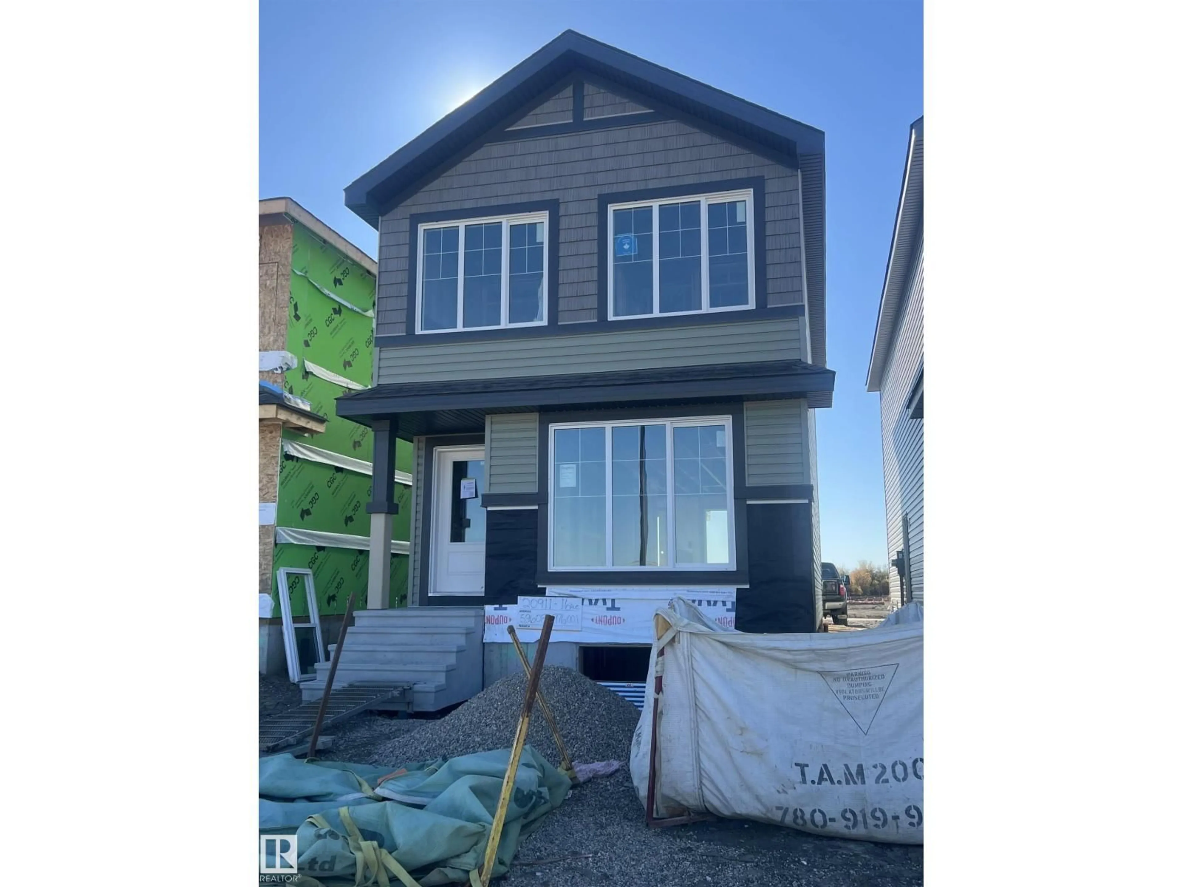 Home with vinyl exterior material, street for 20911 16 AV, Edmonton Alberta T6M1L2