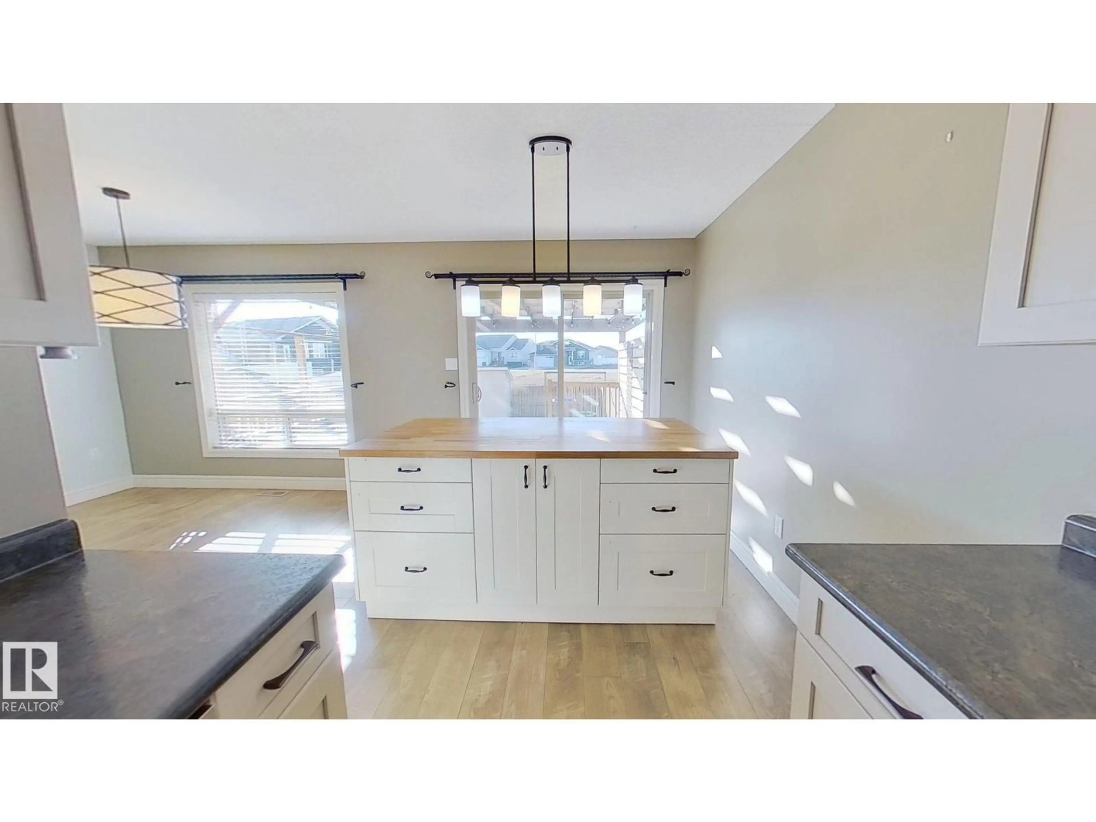 Open concept kitchen, wood/laminate floor for 718 25 ST, Wainwright Alberta T9W0B7