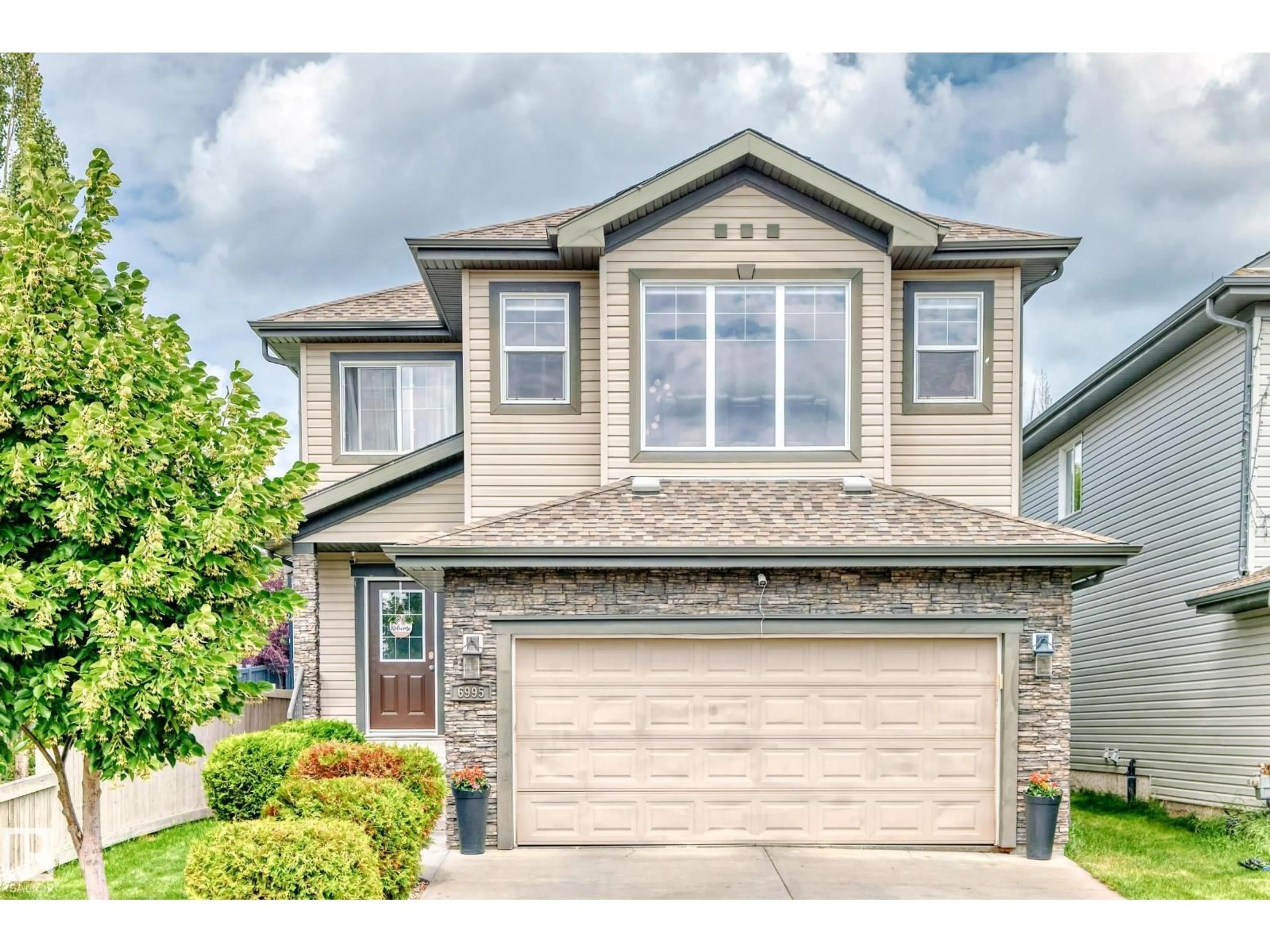 Home with vinyl exterior material, street for 6995 STROM LN, Edmonton Alberta T6R0P1