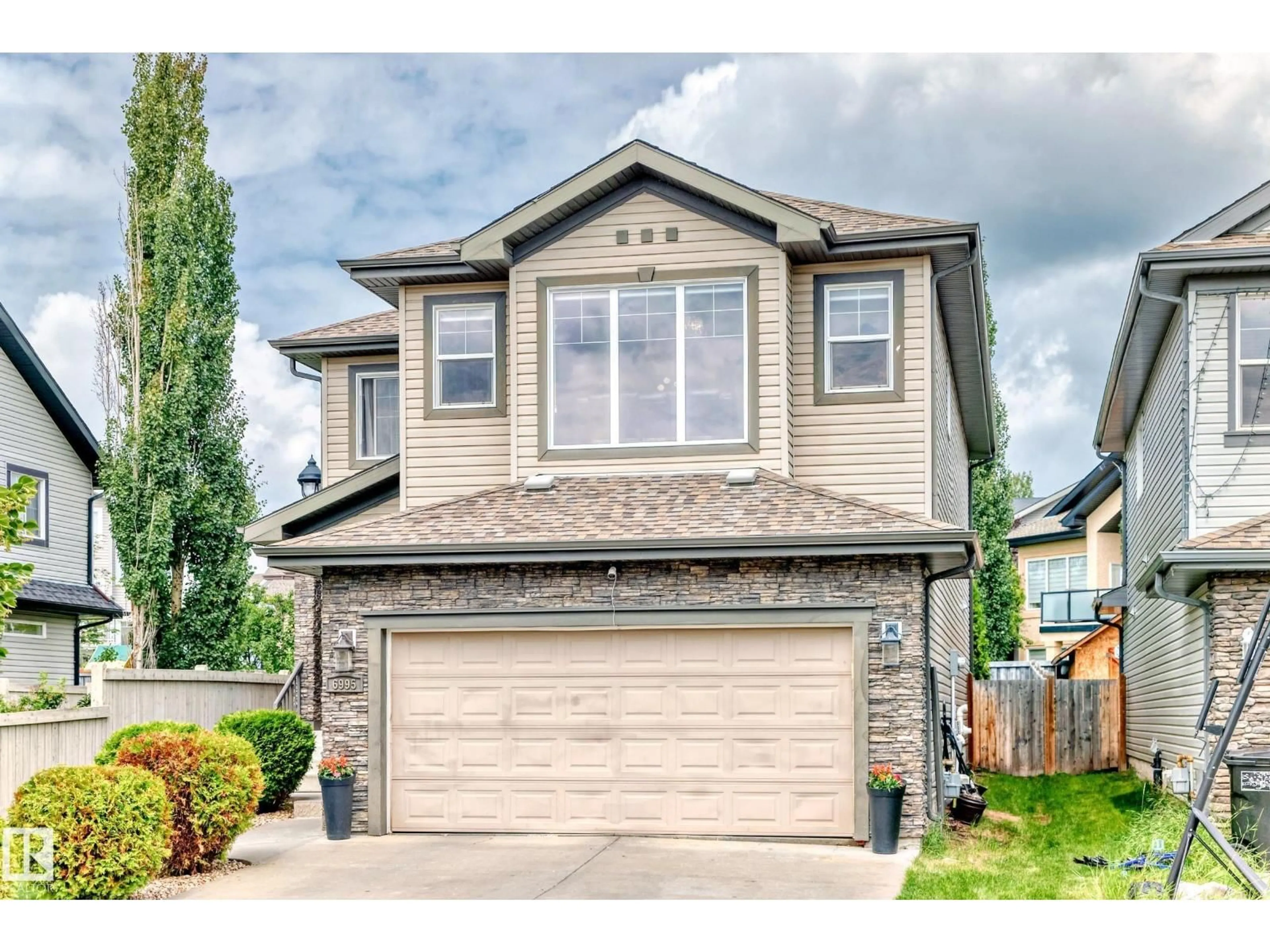 Home with vinyl exterior material, street for 6995 STROM LN, Edmonton Alberta T6R0P1