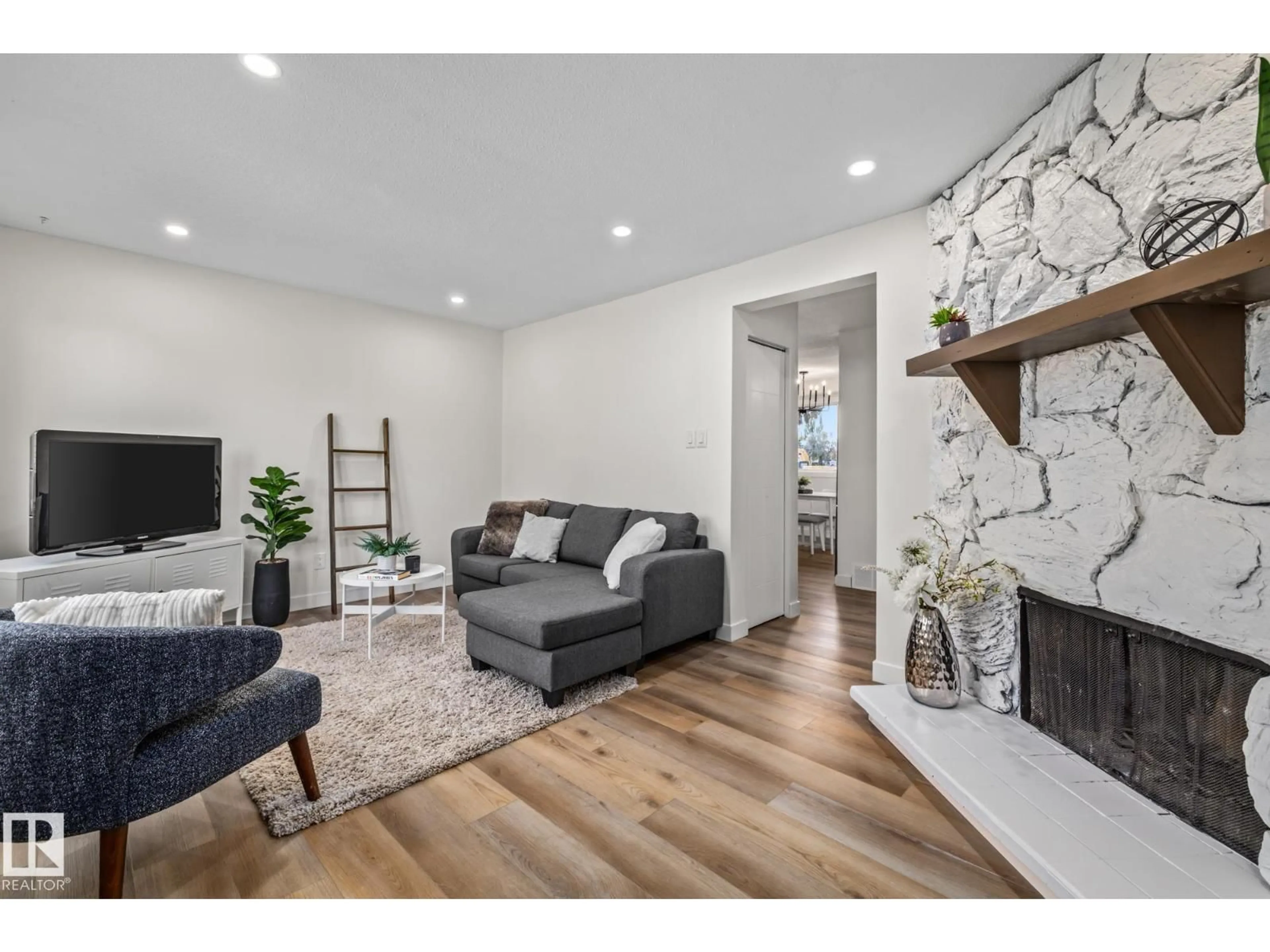 Living room with furniture, wood/laminate floor for 1159 HOOKE RD, Edmonton Alberta T5A4A5