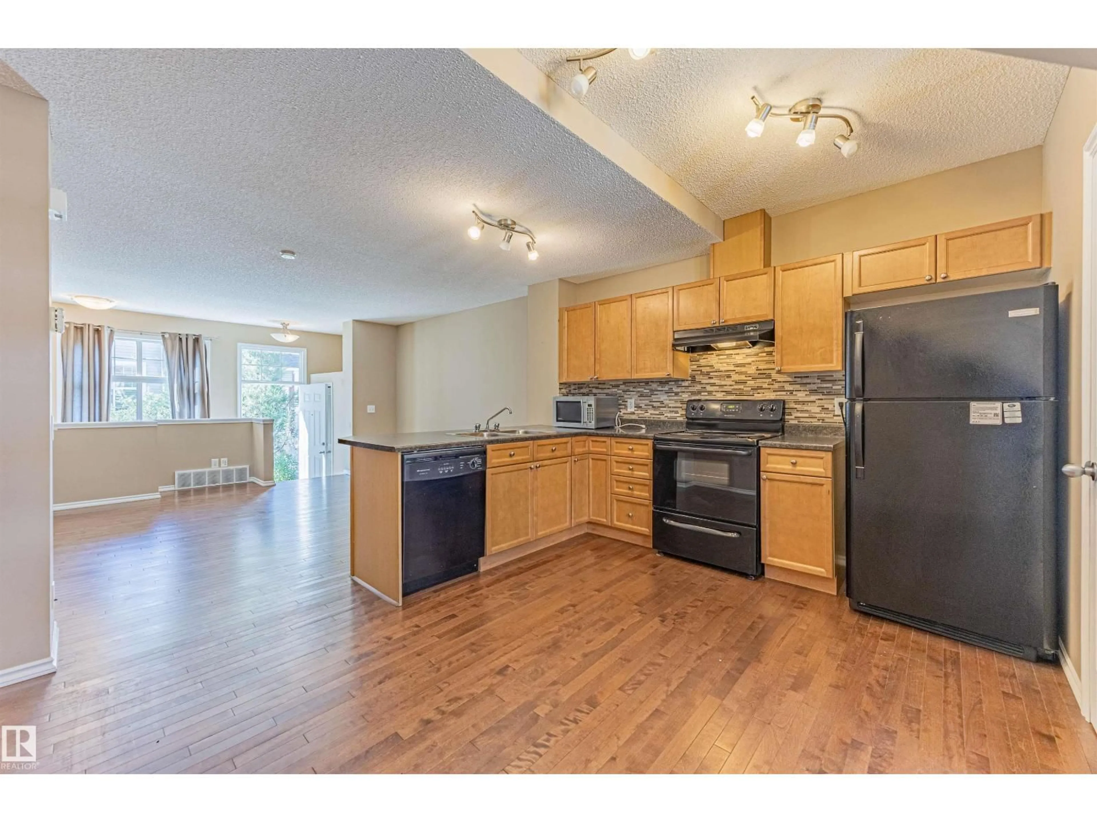 Open concept kitchen, wood/laminate floor for 150 - 5604 199 ST, Edmonton Alberta T6M2Z9