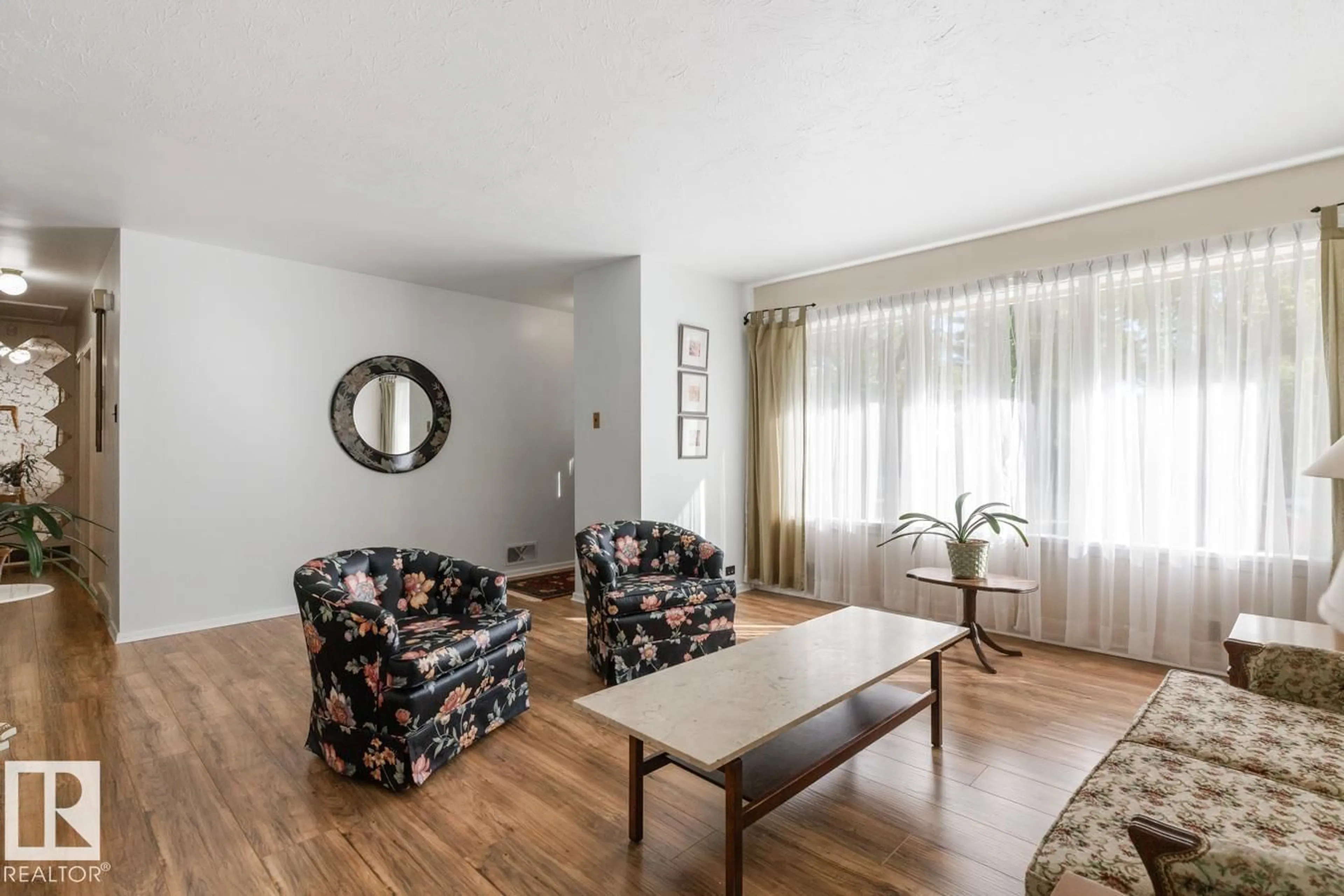 Living room with furniture, wood/laminate floor for 11028 131 ST NW, Edmonton Alberta T5N1B8