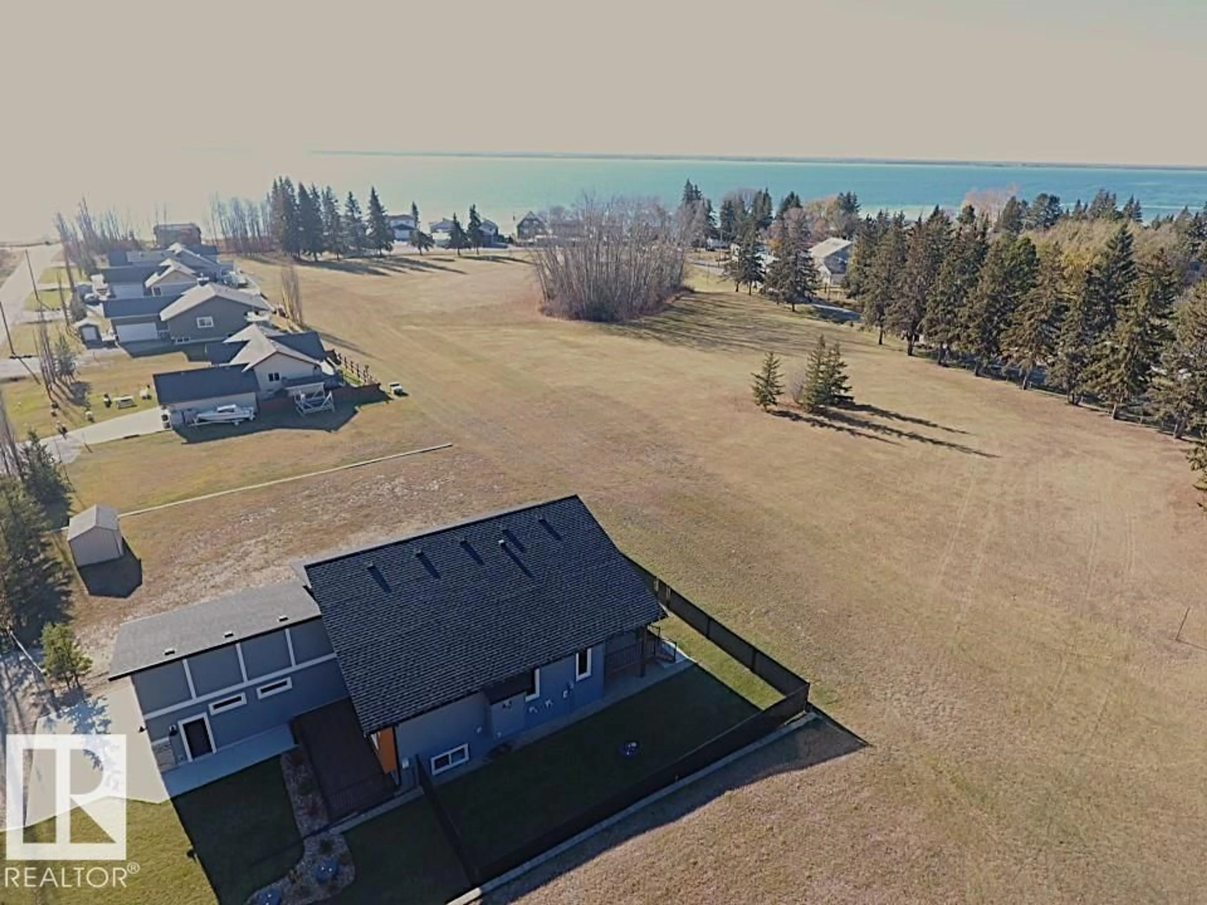 A pic from outside/outdoor area/front of a property/back of a property/a pic from drone, water/lake/river/ocean view for 102 1 STREET, Rural Lac Ste. Anne County Alberta T0E1A0