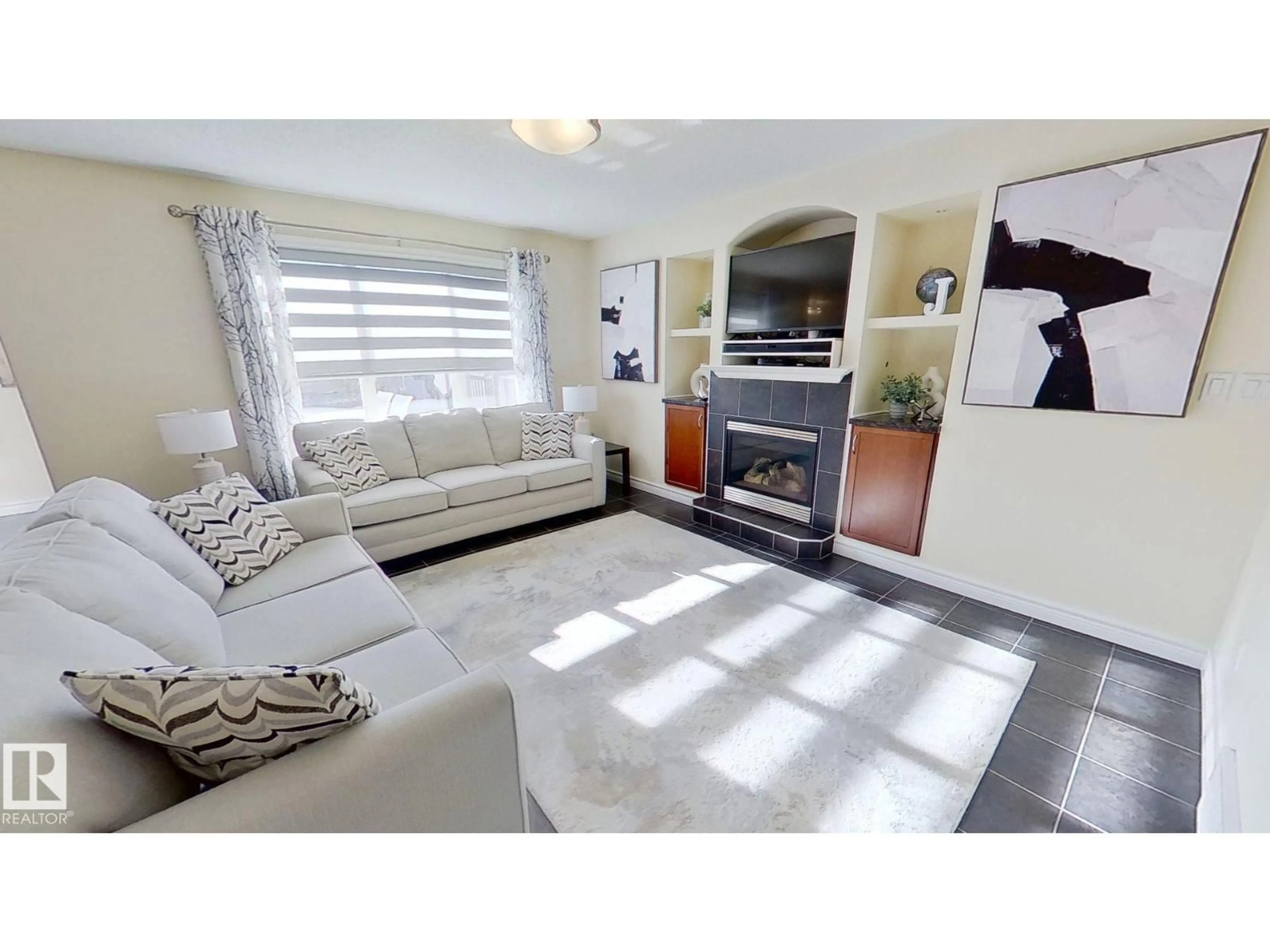 Living room with furniture, ceramic/tile floor for 14029 145 AV, Edmonton Alberta T6V1Y2