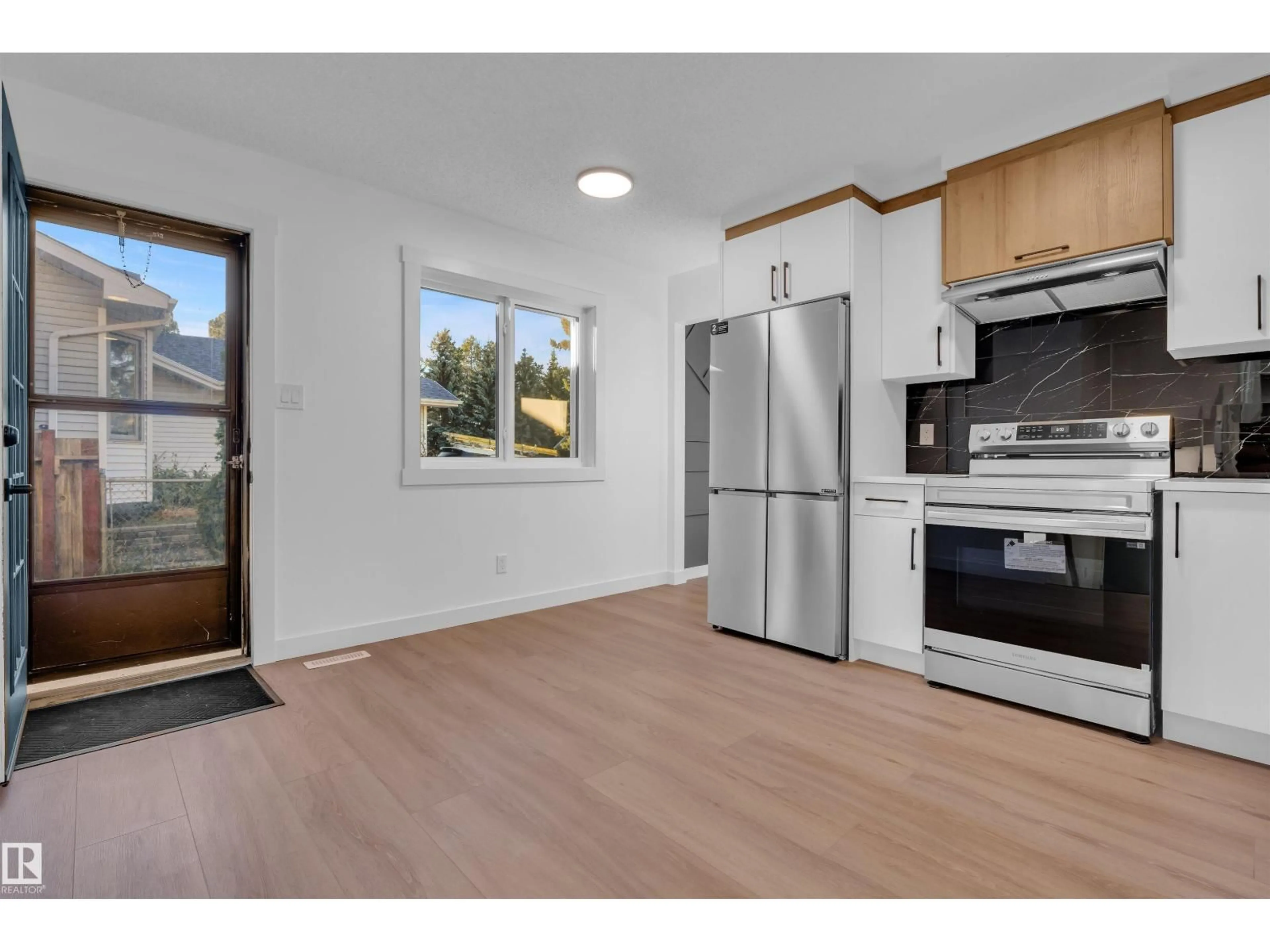 Open concept kitchen, wood/laminate floor for 1111 49A ST, Edmonton Alberta T6L4C5