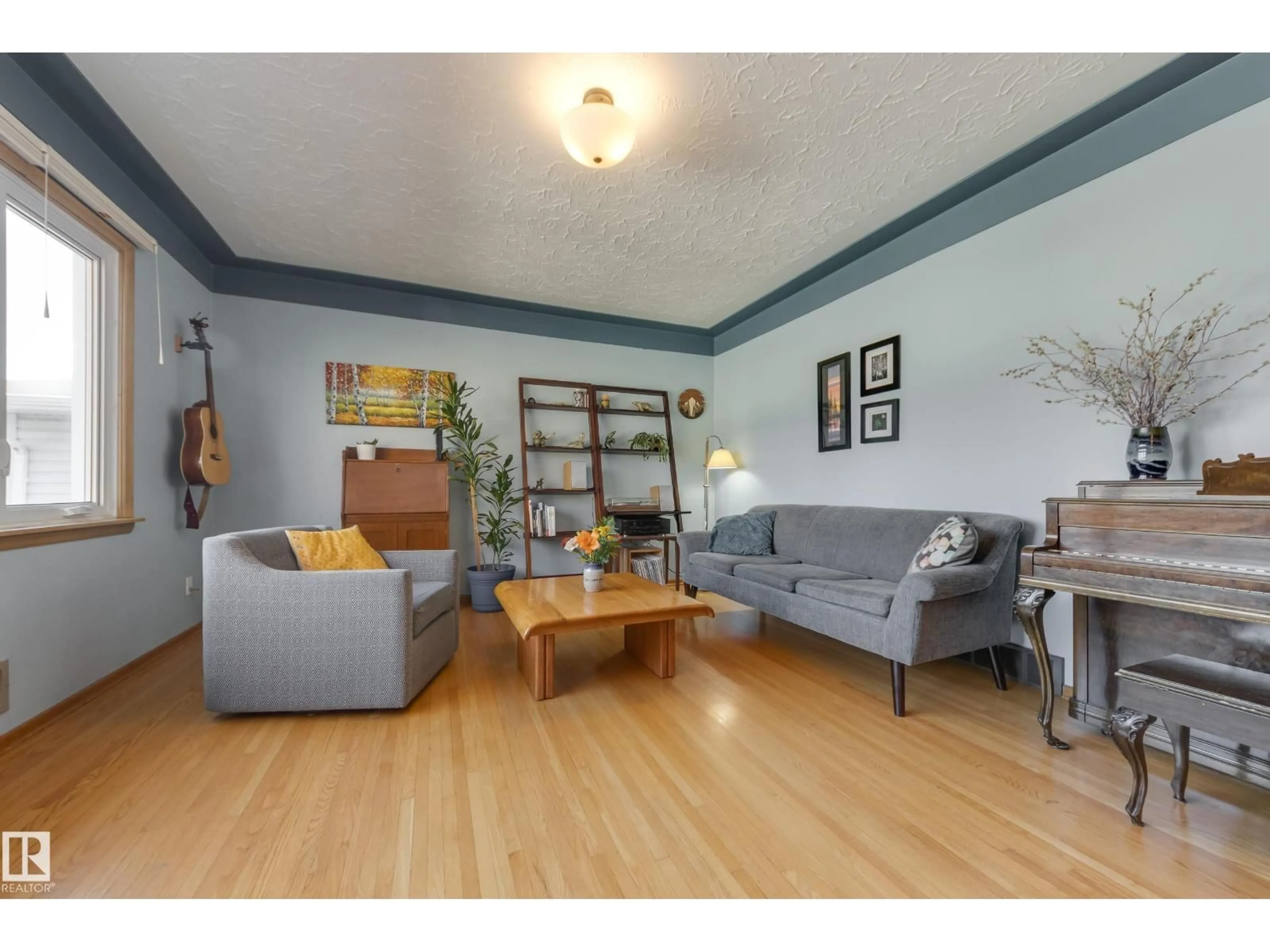 Living room with furniture, wood/laminate floor for 9651 66 AV, Edmonton Alberta T6E0M2