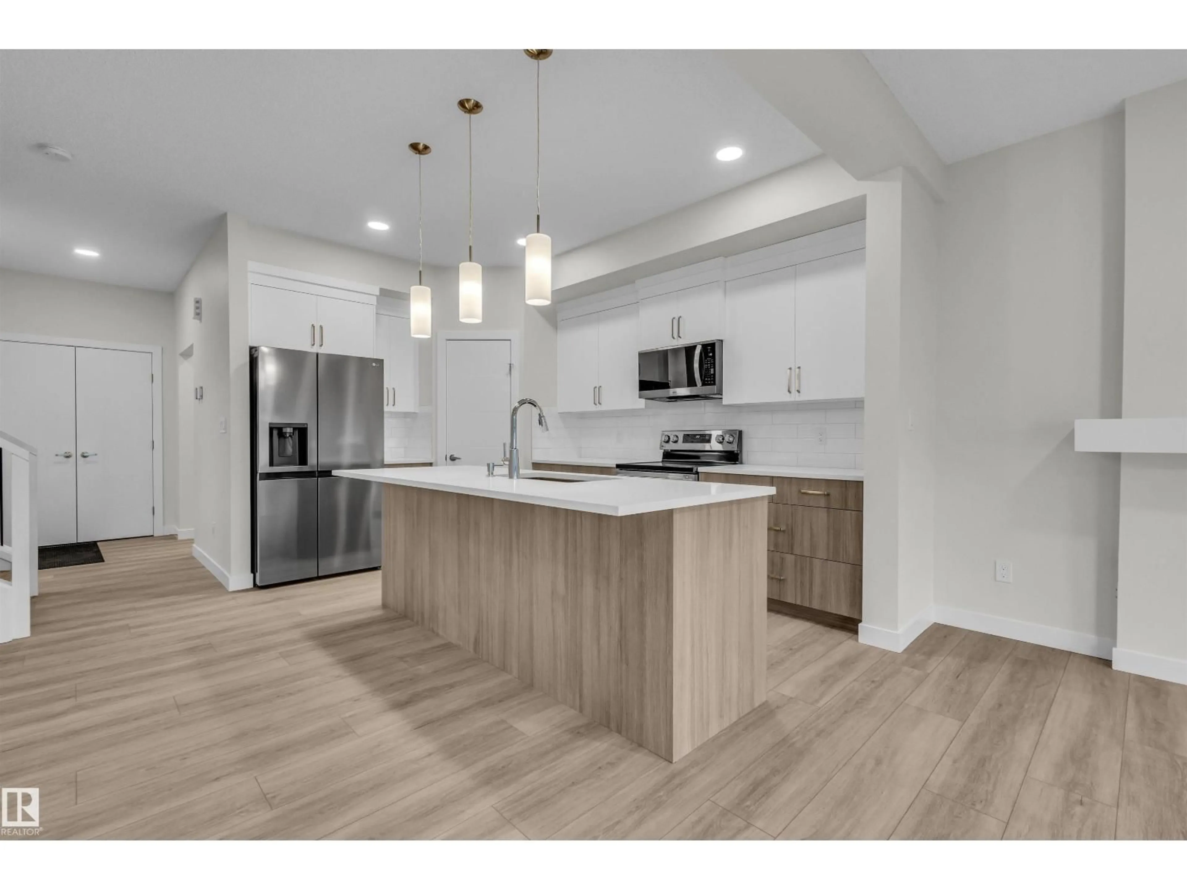 Open concept kitchen, wood/laminate floor for 1079 BERG PL, Leduc Alberta T9E1T6