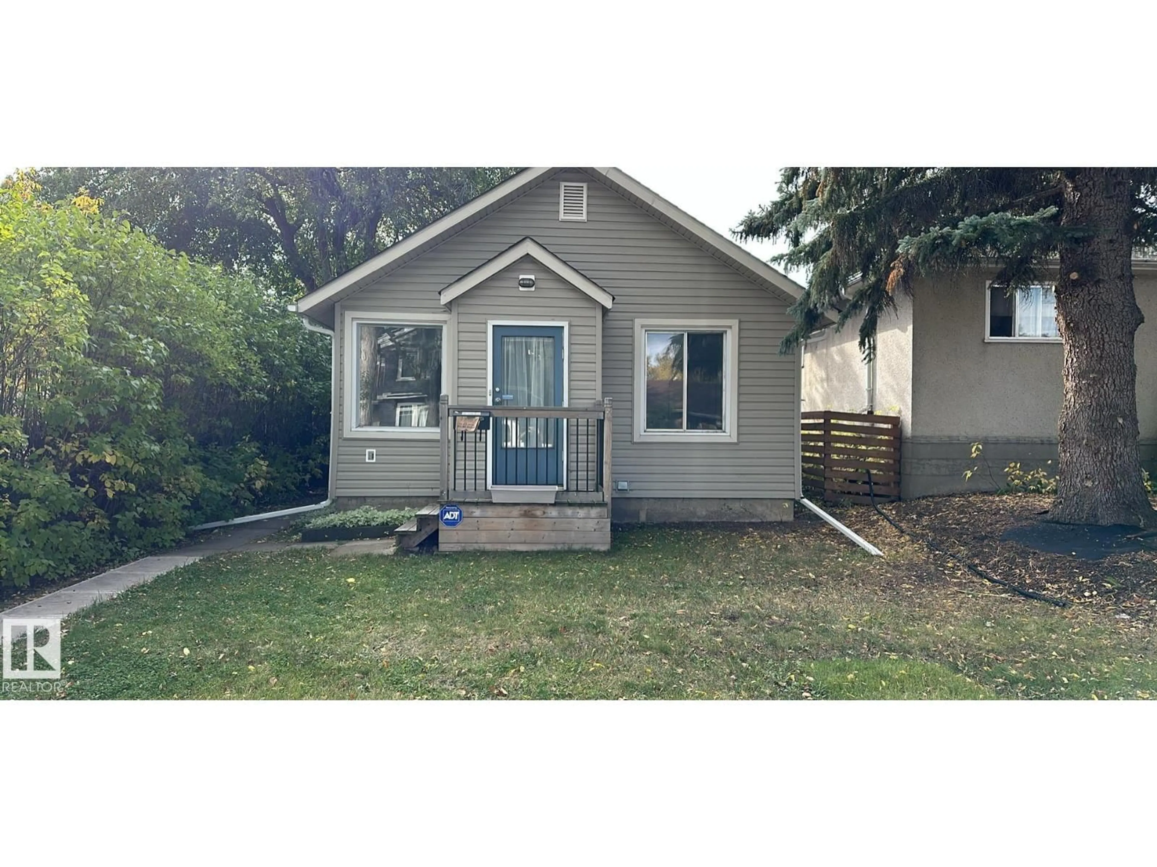 Home with vinyl exterior material, street for 10657 64 AV, Edmonton Alberta T6H1T1
