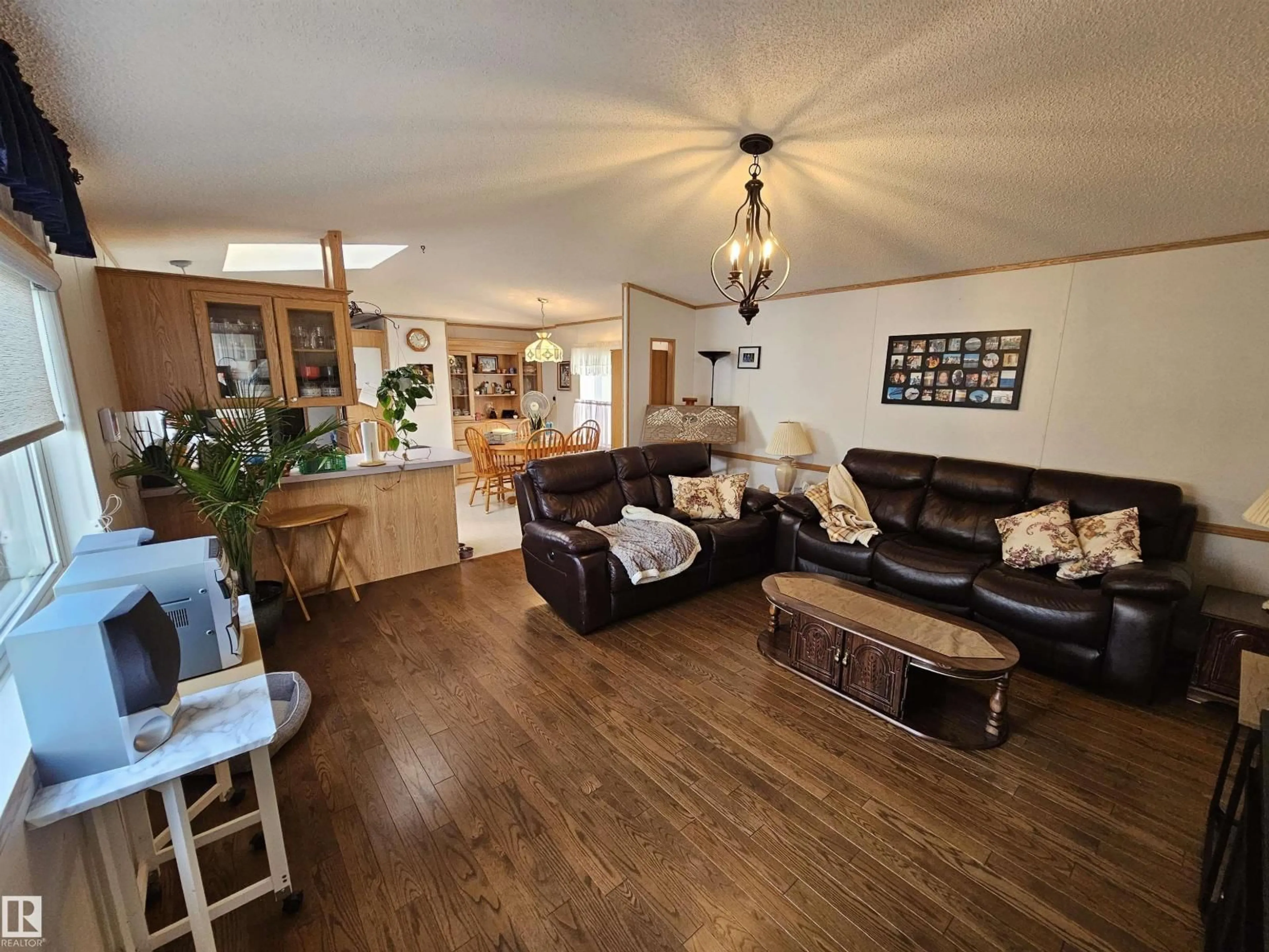 Living room with furniture, wood/laminate floor for 4819 - 94 51 AVE AVE, Millet Alberta T0C1Z0