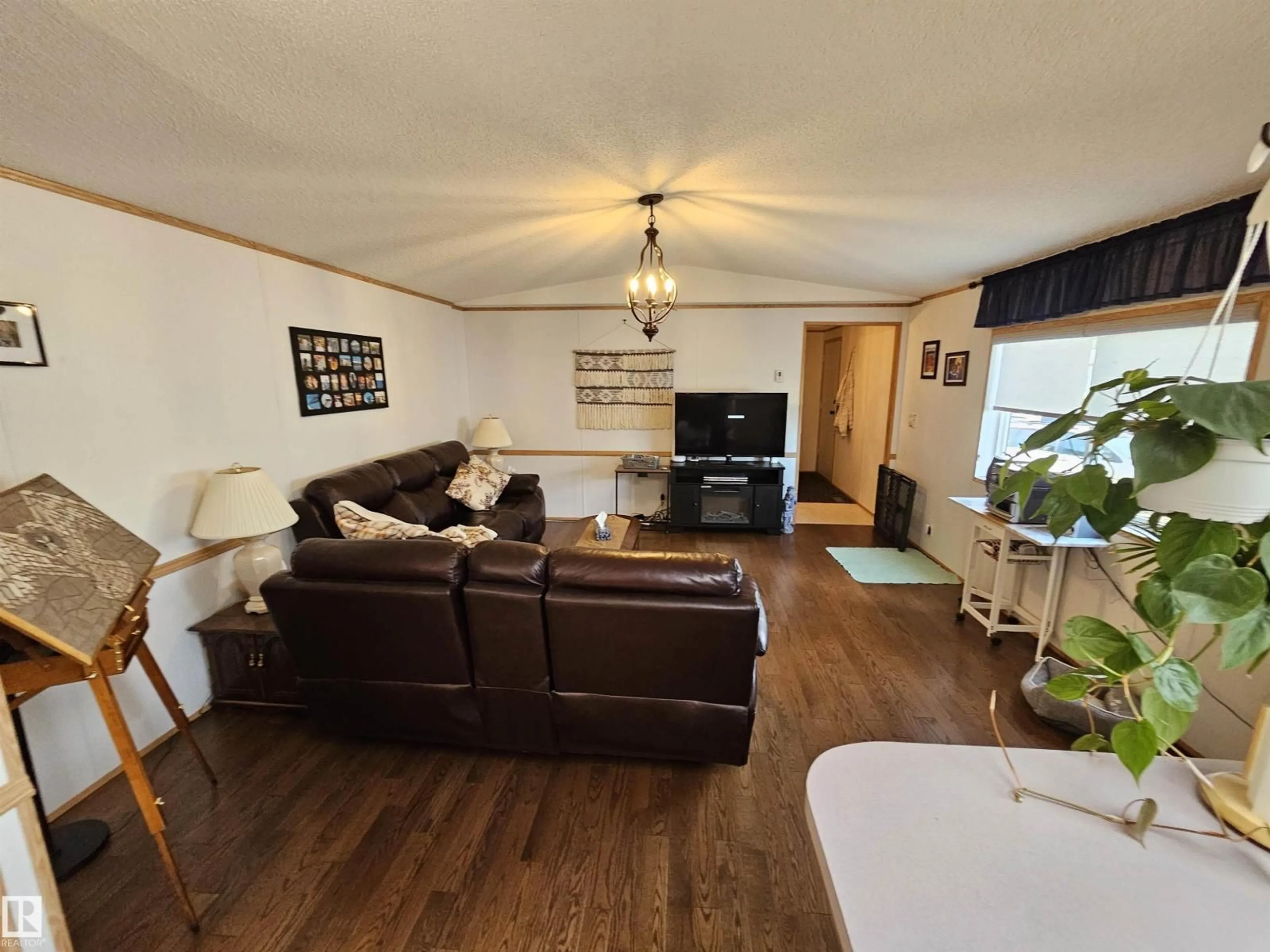 Living room with furniture, wood/laminate floor for 4819 - 94 51 AVE AVE, Millet Alberta T0C1Z0