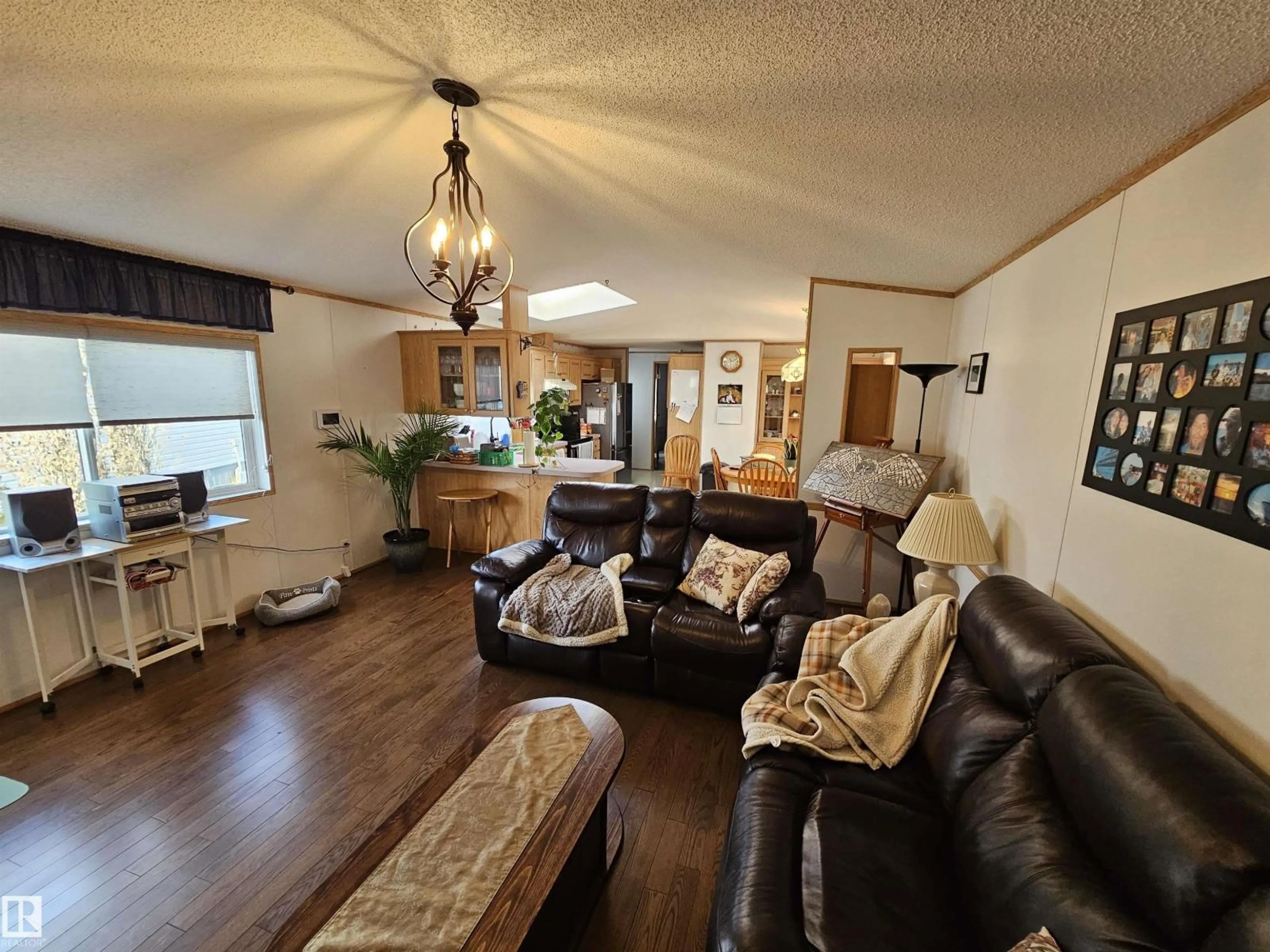 Living room with furniture, wood/laminate floor for 4819 - 94 51 AVE AVE, Millet Alberta T0C1Z0