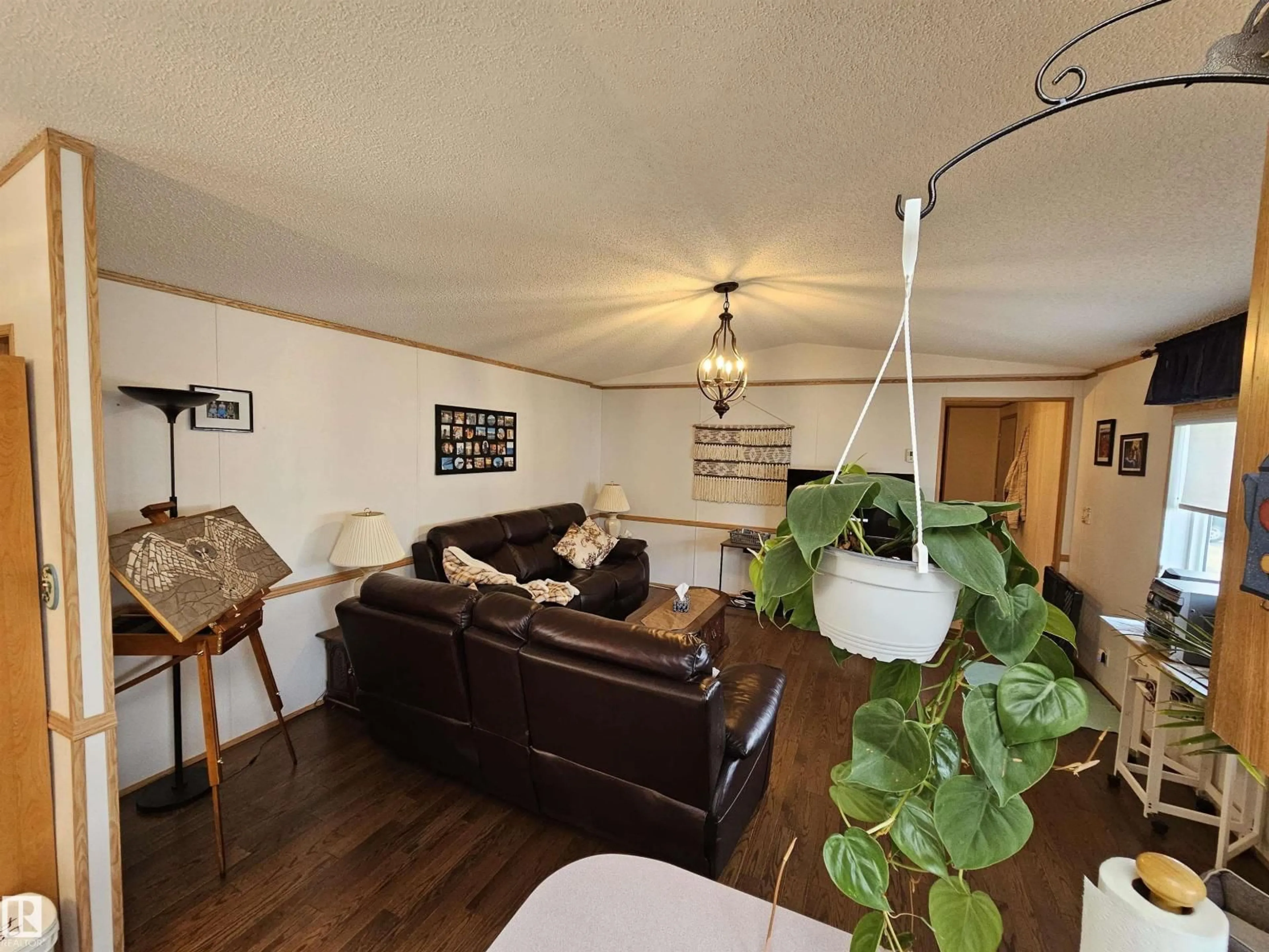 Living room with furniture, wood/laminate floor for 4819 - 94 51 AVE AVE, Millet Alberta T0C1Z0