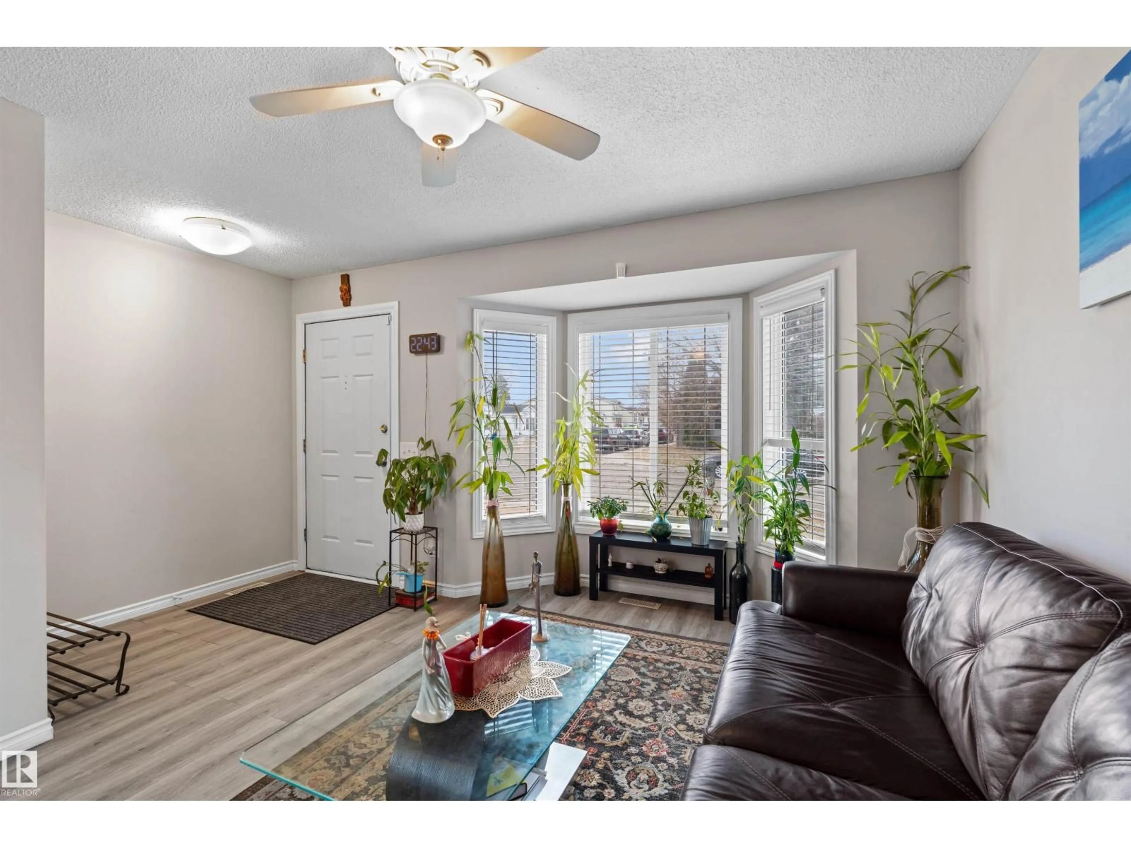 Living room with furniture, wood/laminate floor for 8304 157 AV, Edmonton Alberta T5Z2P8