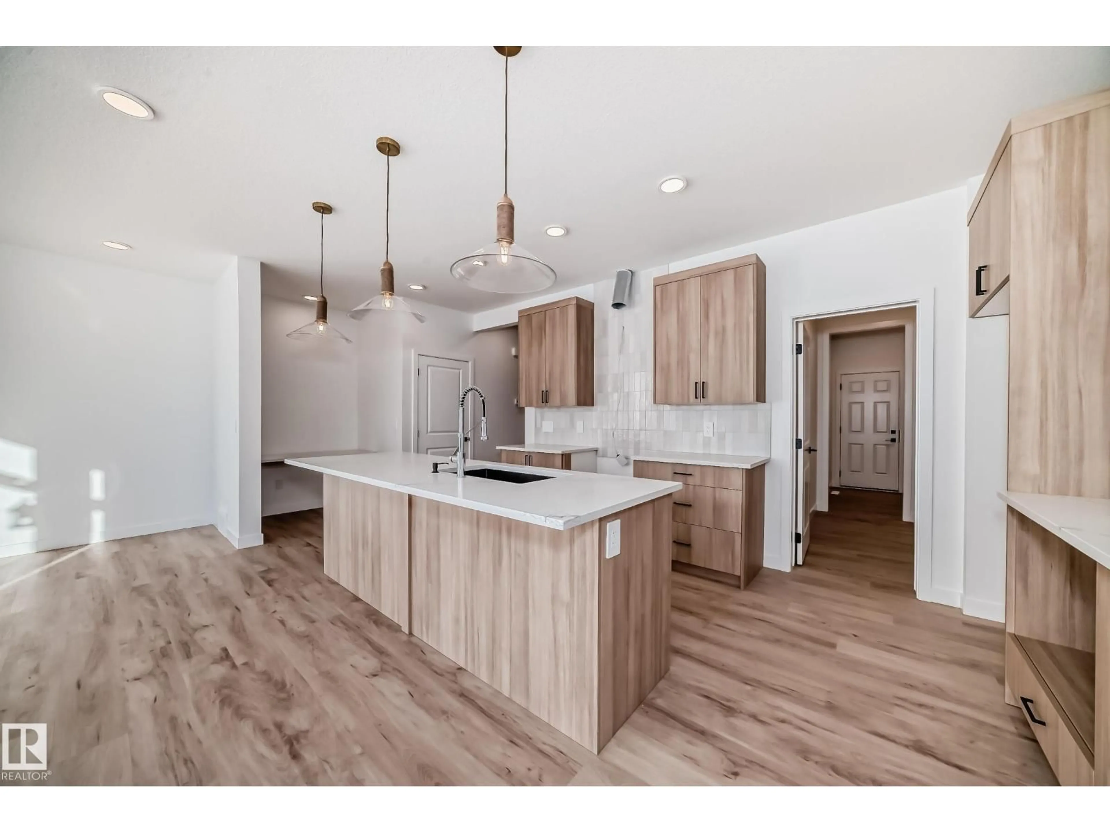 Open concept kitchen, wood/laminate floor for SW - 8215 KIRIAK LO, Edmonton Alberta T6W5S2