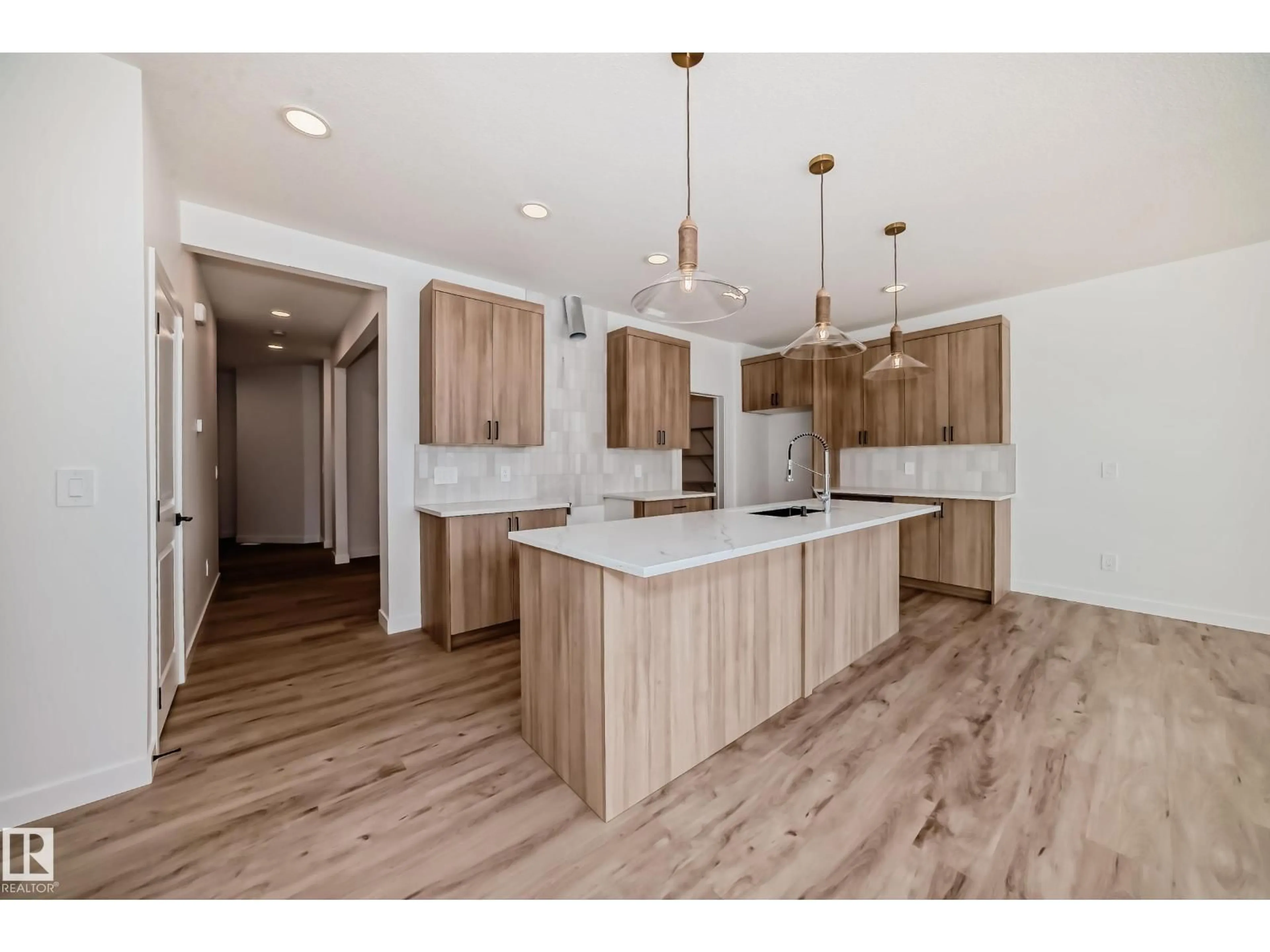 Open concept kitchen, wood/laminate floor for SW - 8215 KIRIAK LO, Edmonton Alberta T6W5S2