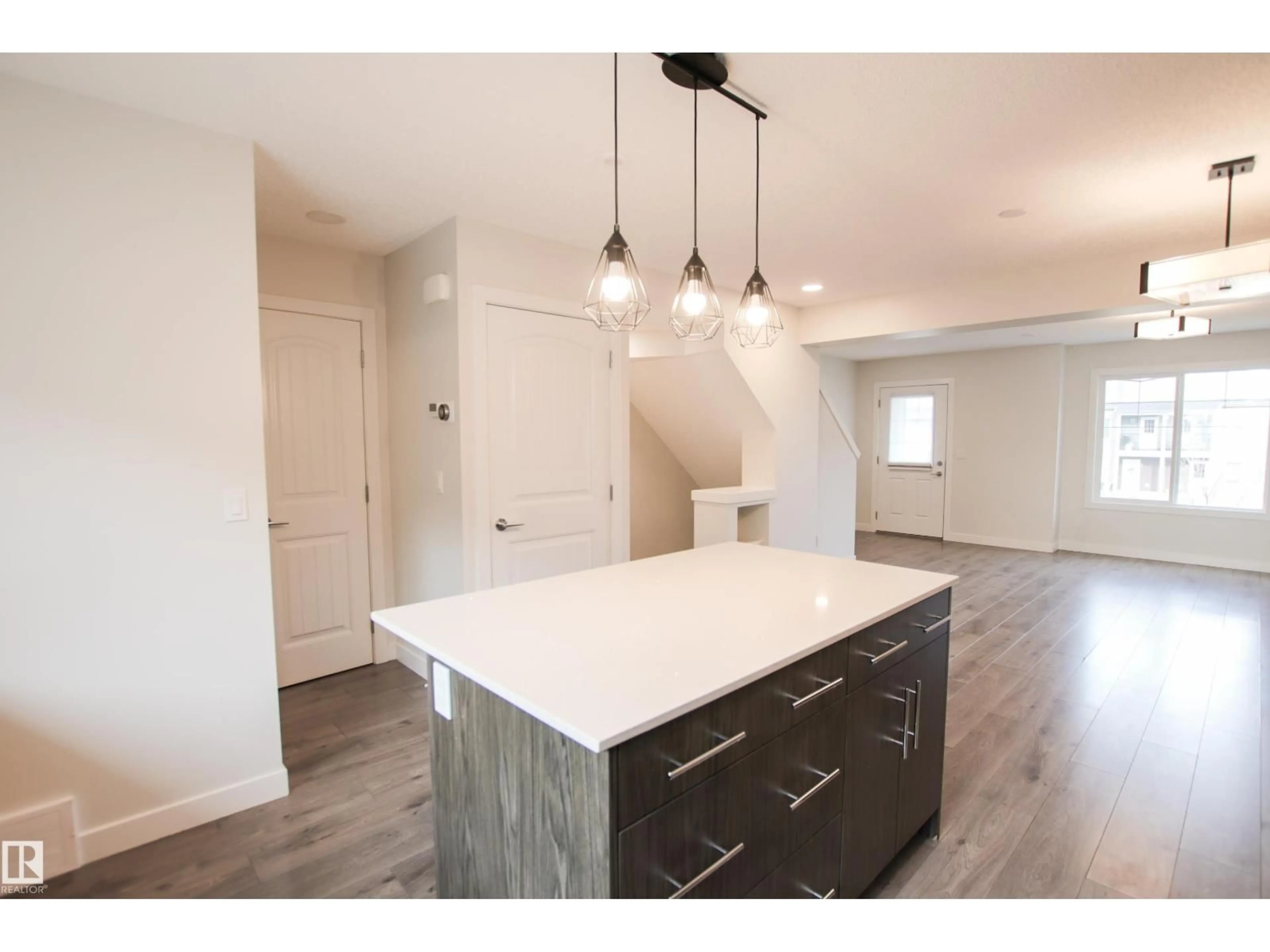Open concept kitchen, wood/laminate floor for #38 - 3025 151 AV, Edmonton Alberta T5Y3W4