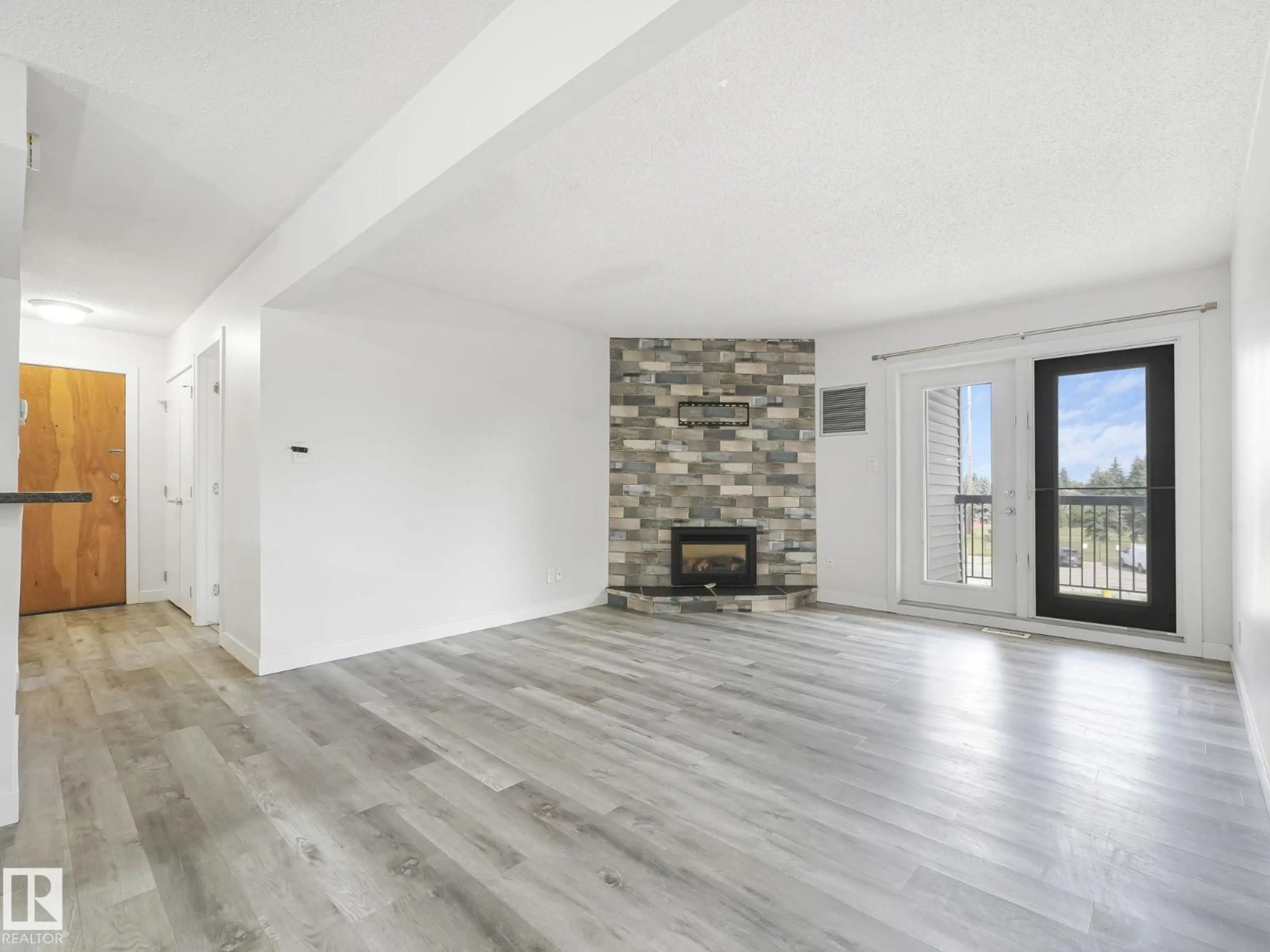 Living room with furniture, wood/laminate floor for #303 - 10528 29 AV, Edmonton Alberta T6J4J2