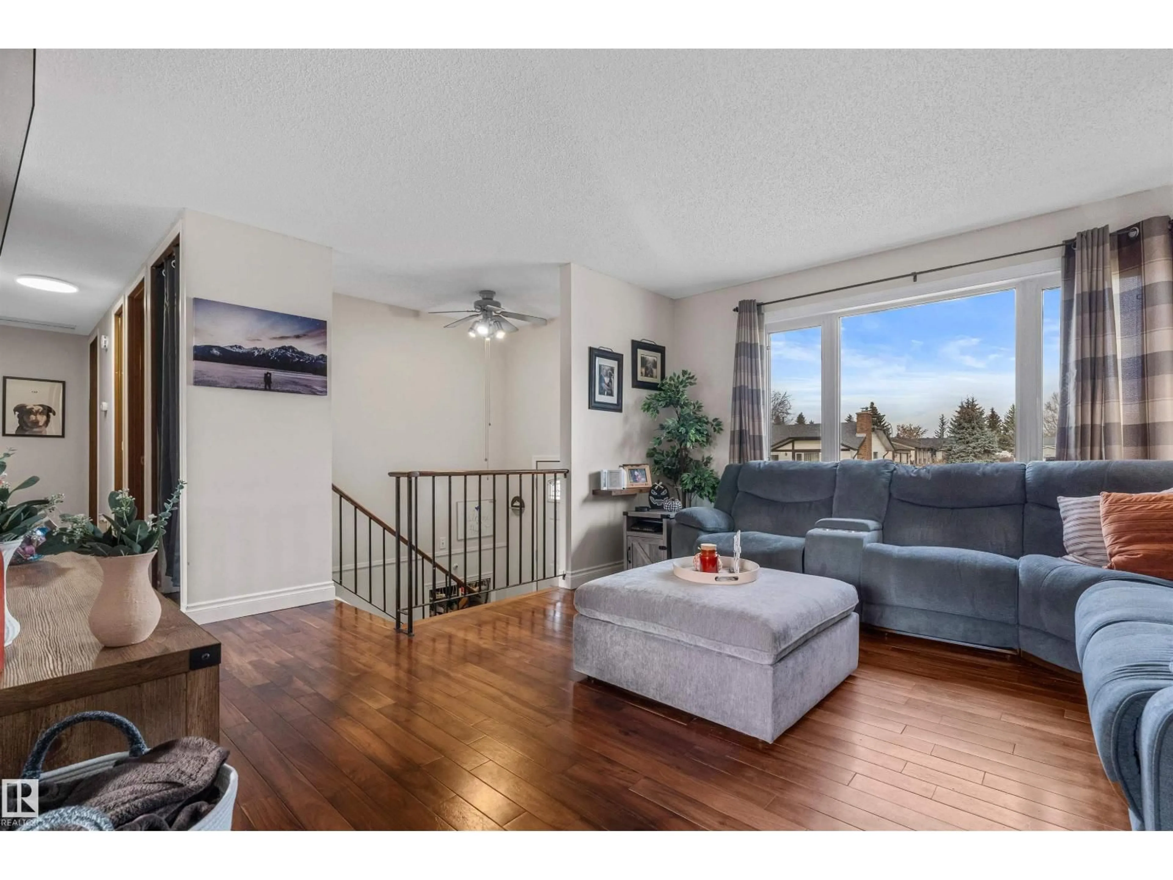 Living room with furniture, wood/laminate floor for NW - 9807 165 AV, Edmonton Alberta T5X4Z1
