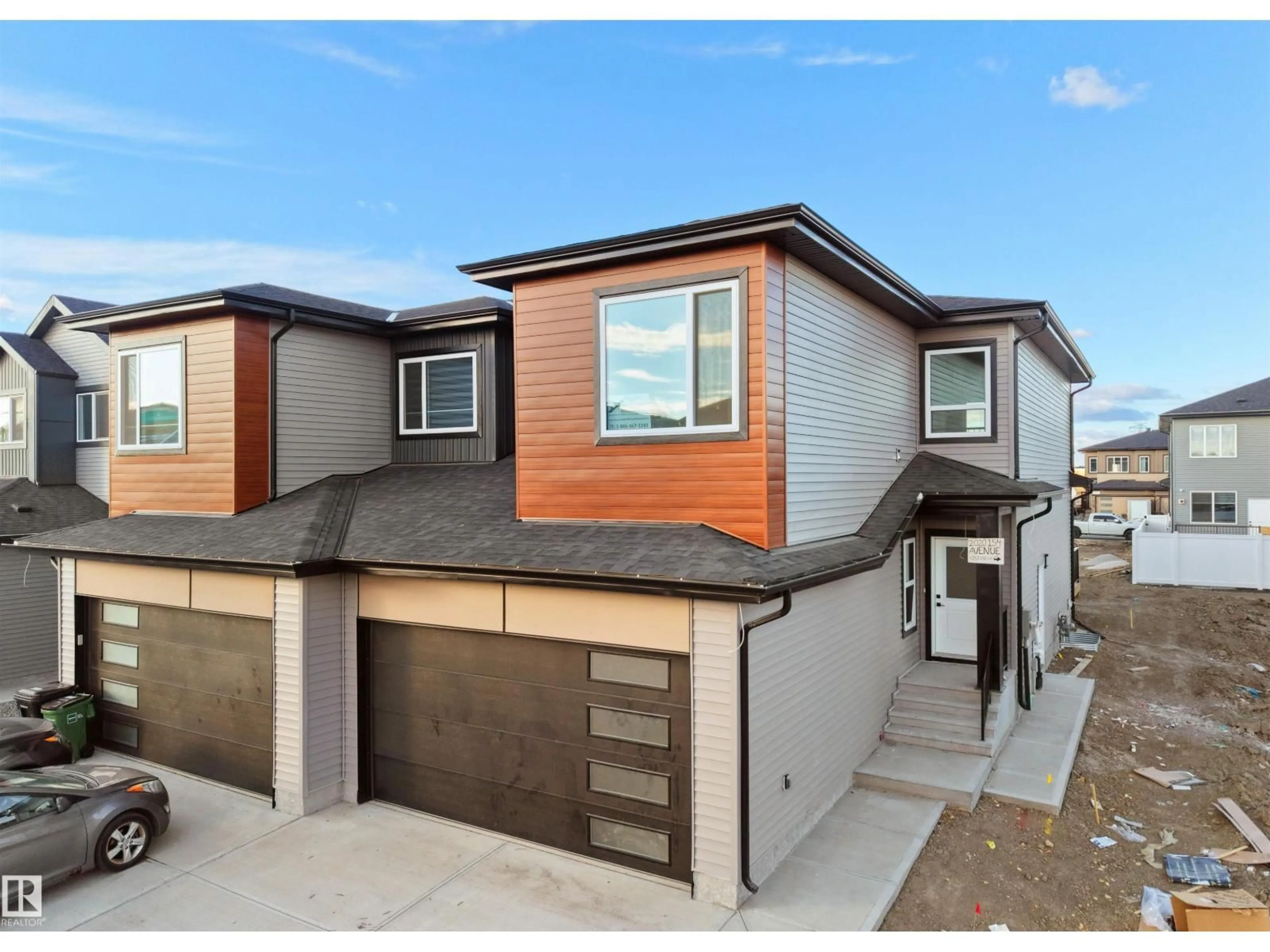 Home with vinyl exterior material, street for NW - 2020 154 AV, Edmonton Alberta T5Y2R7