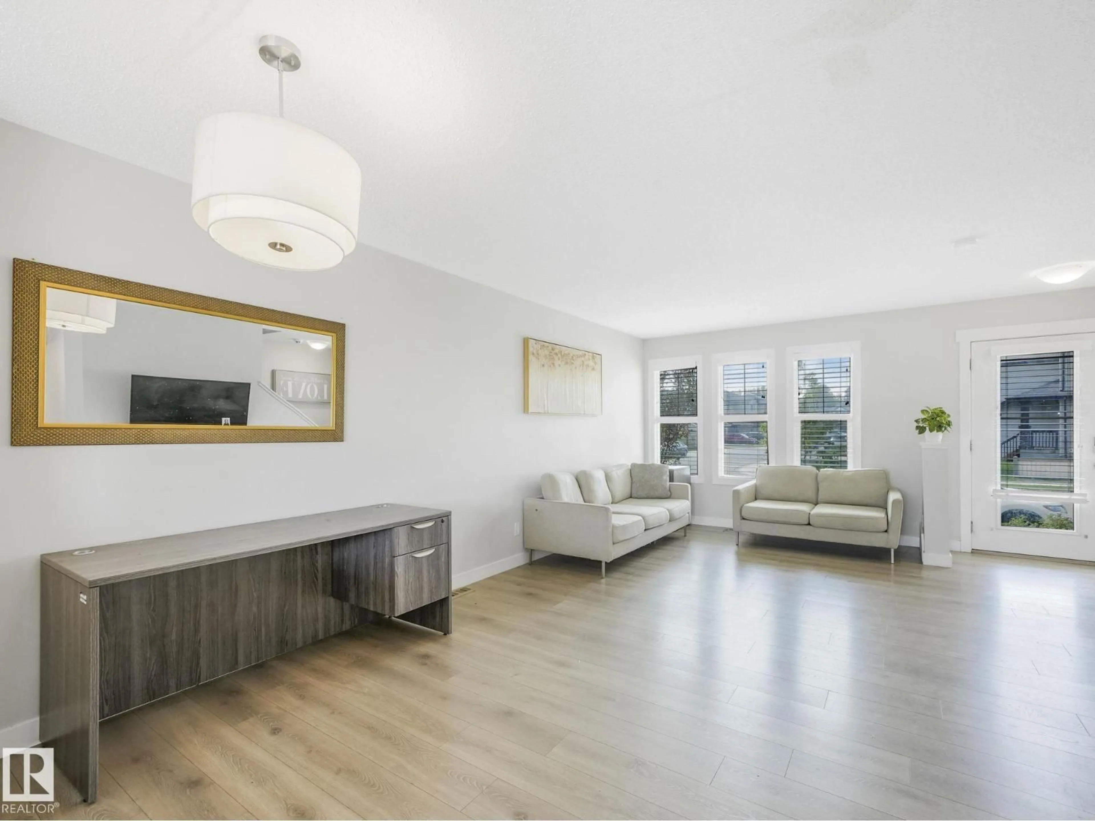 Living room with furniture, wood/laminate floor for 648 LEWIS GREENS DR, Edmonton Alberta T5T7G4