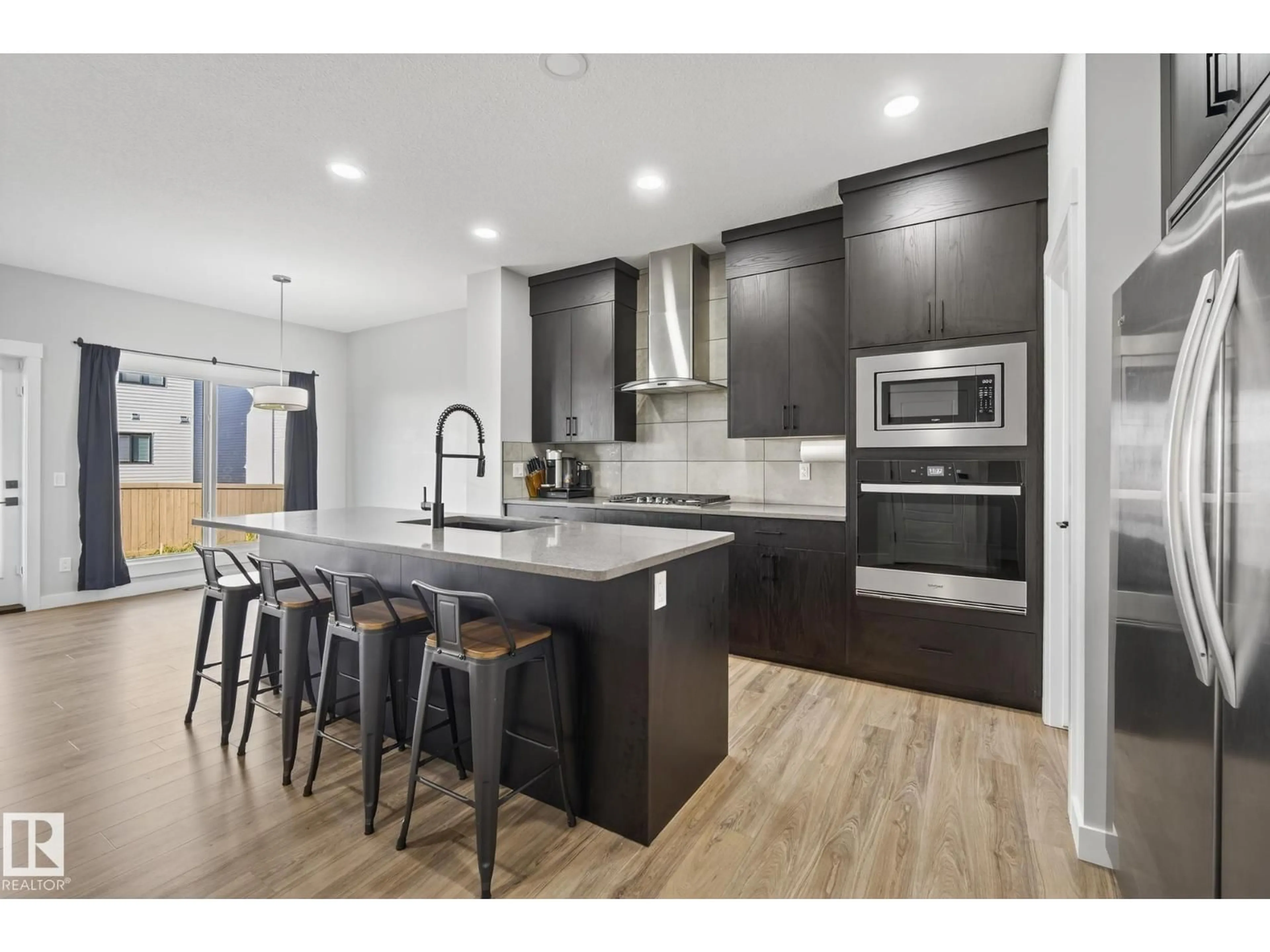 Open concept kitchen, wood/laminate floor for 9704 224 ST, Edmonton Alberta T5T7P4