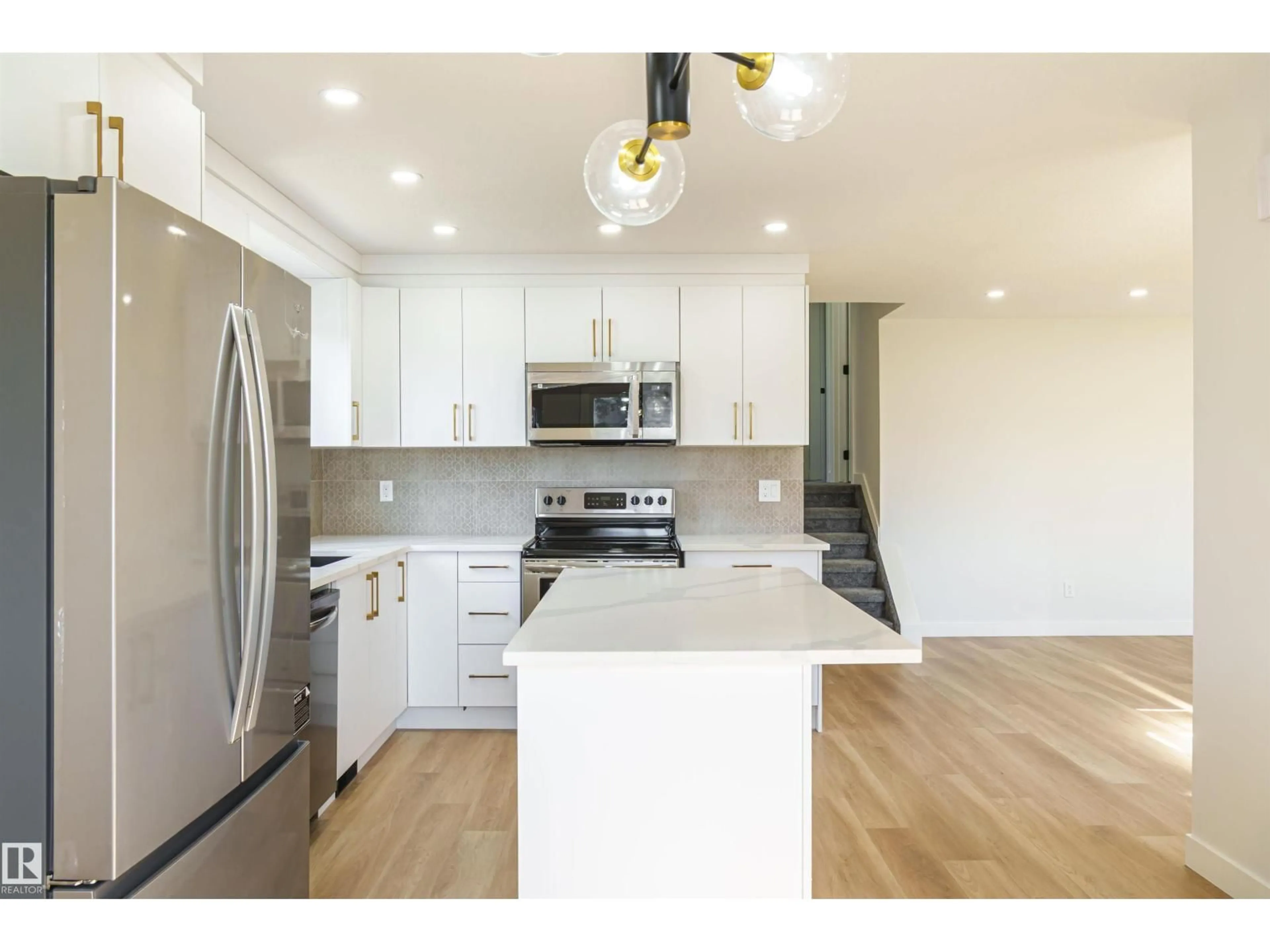 Open concept kitchen, wood/laminate floor for 3710 41 AV, Edmonton Alberta T6L5M2