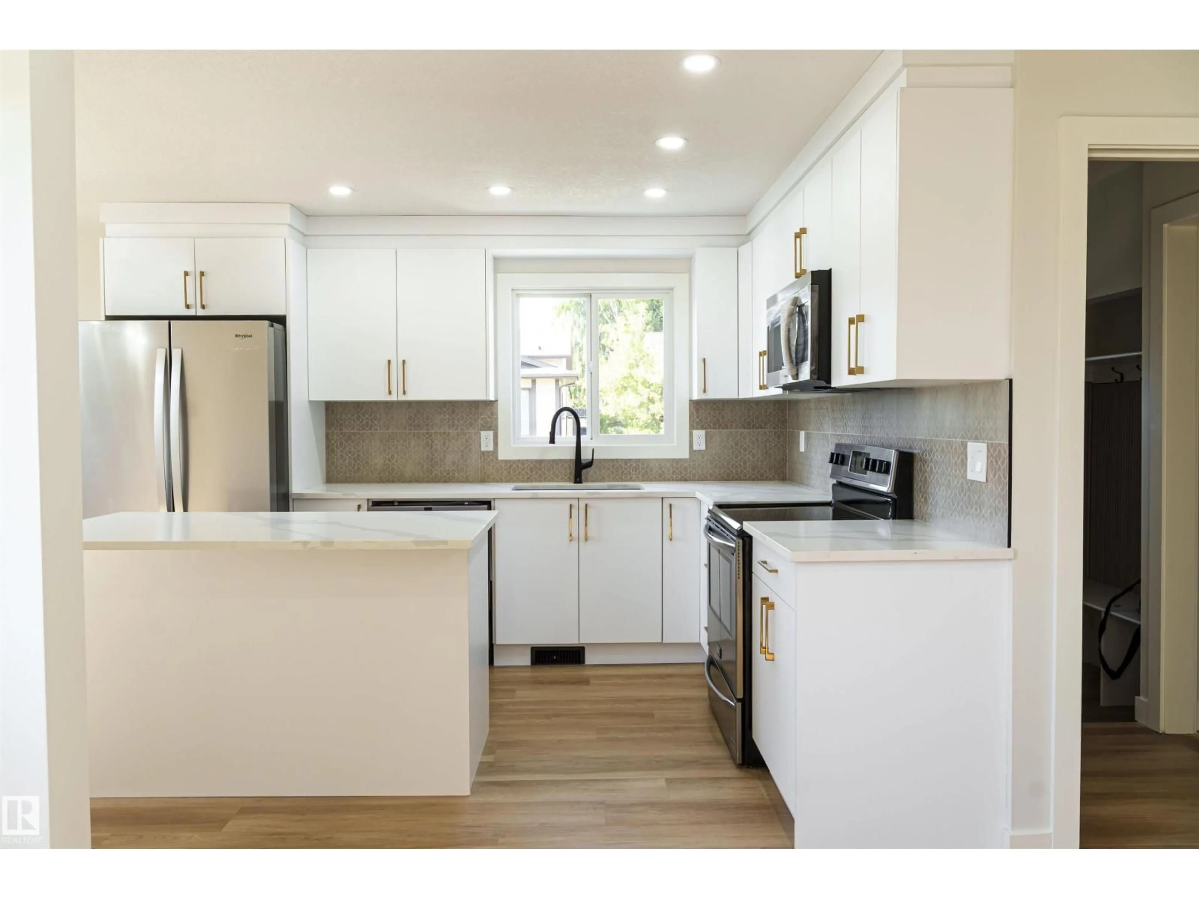 Open concept kitchen, wood/laminate floor for 3710 41 AV, Edmonton Alberta T6L5M2