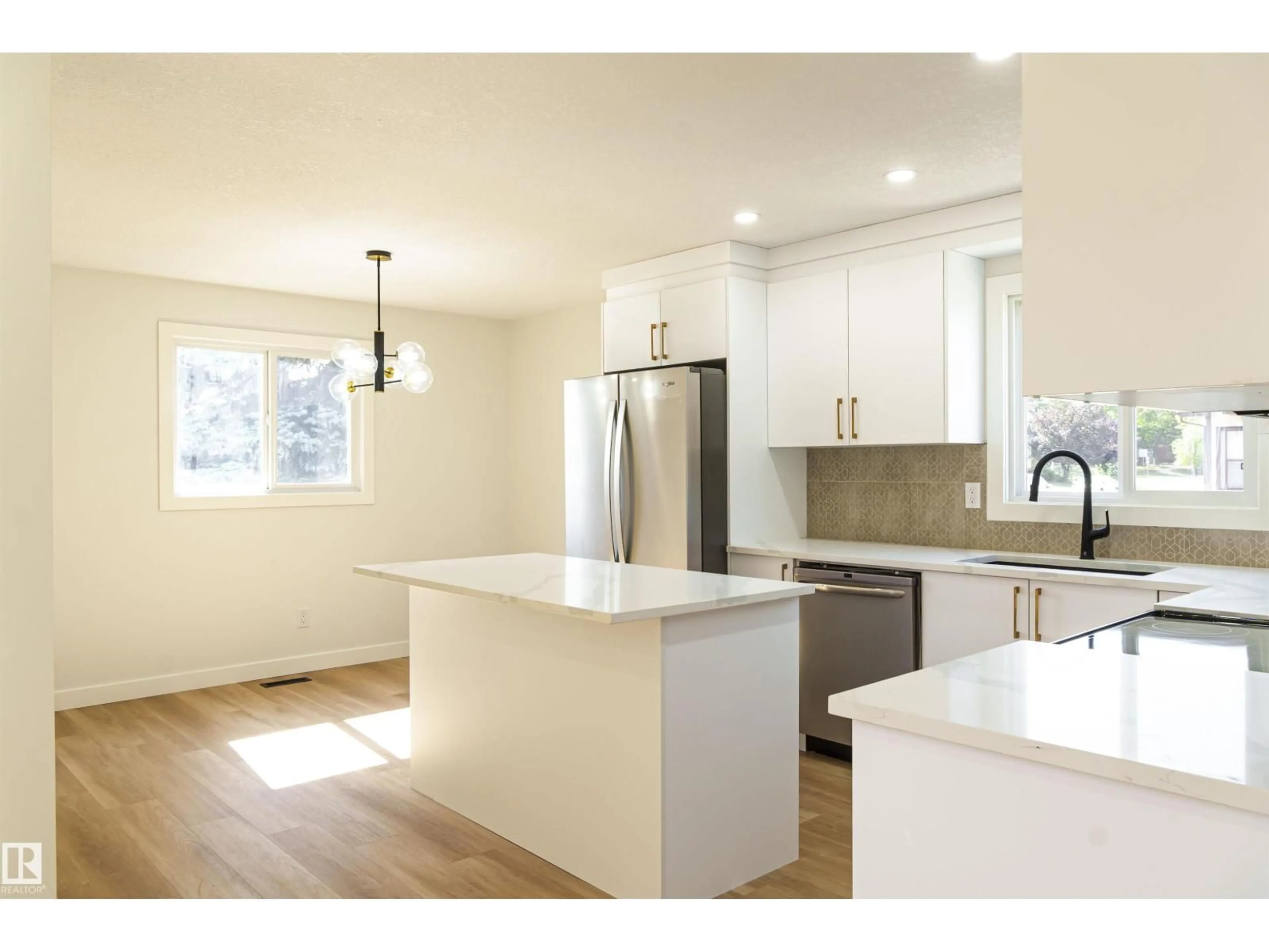 Open concept kitchen, wood/laminate floor for 3710 41 AV, Edmonton Alberta T6L5M2