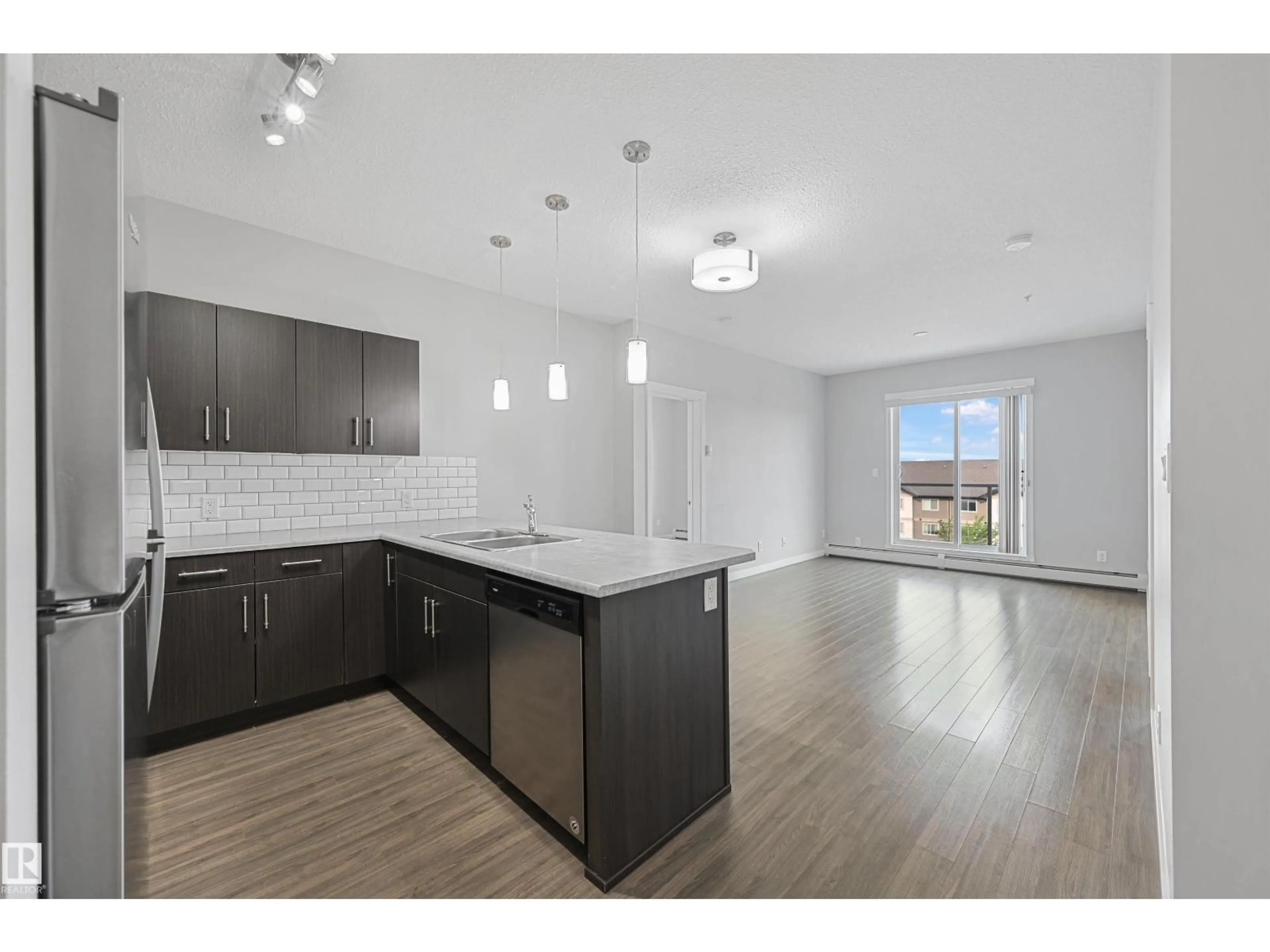 Open concept kitchen, wood/laminate floor for #405 - 812 WELSH DR, Edmonton Alberta T6X1Y7