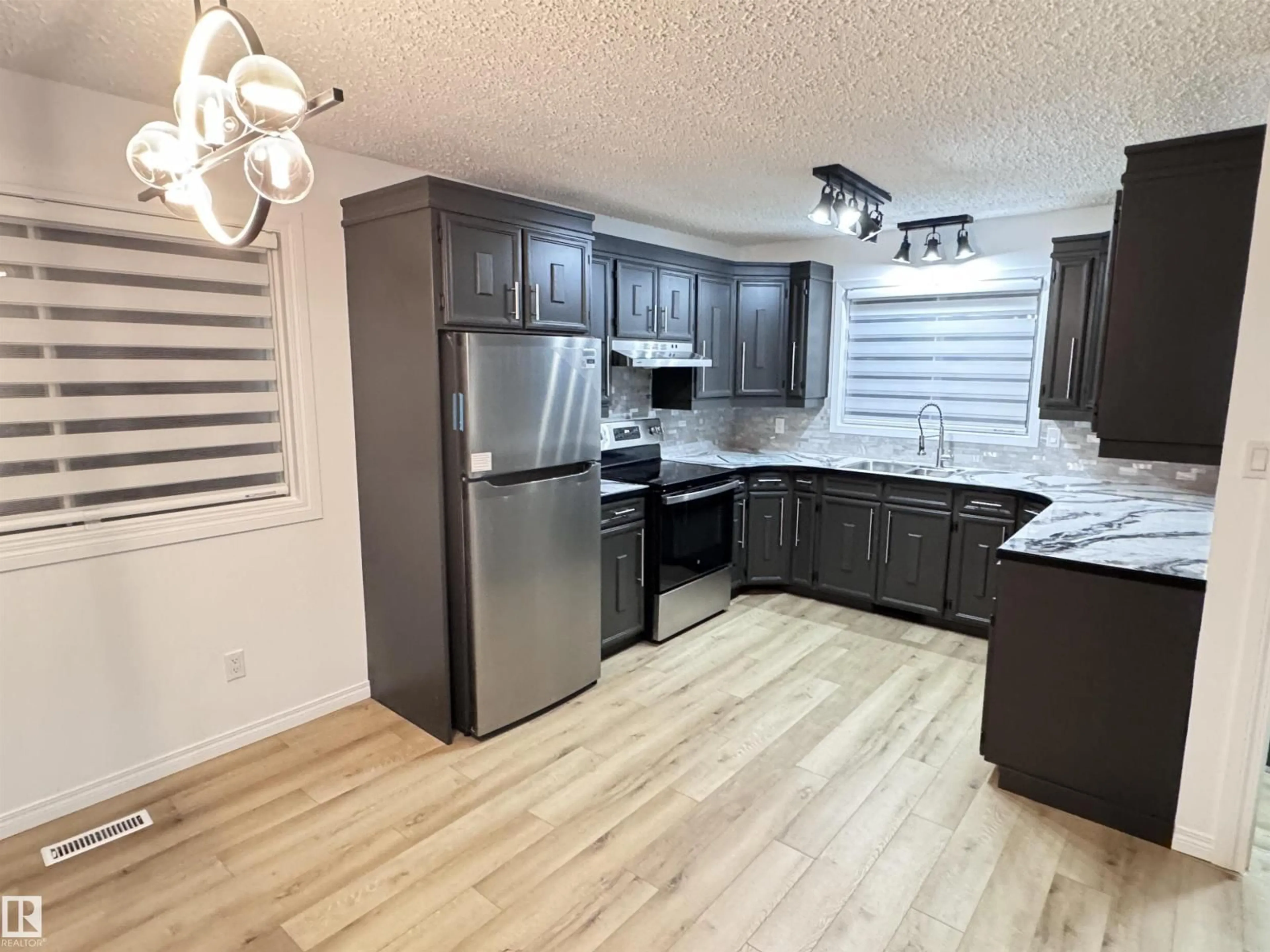 Open concept kitchen, wood/laminate floor for 10208 101 ST, Westlock Alberta T7P1X9