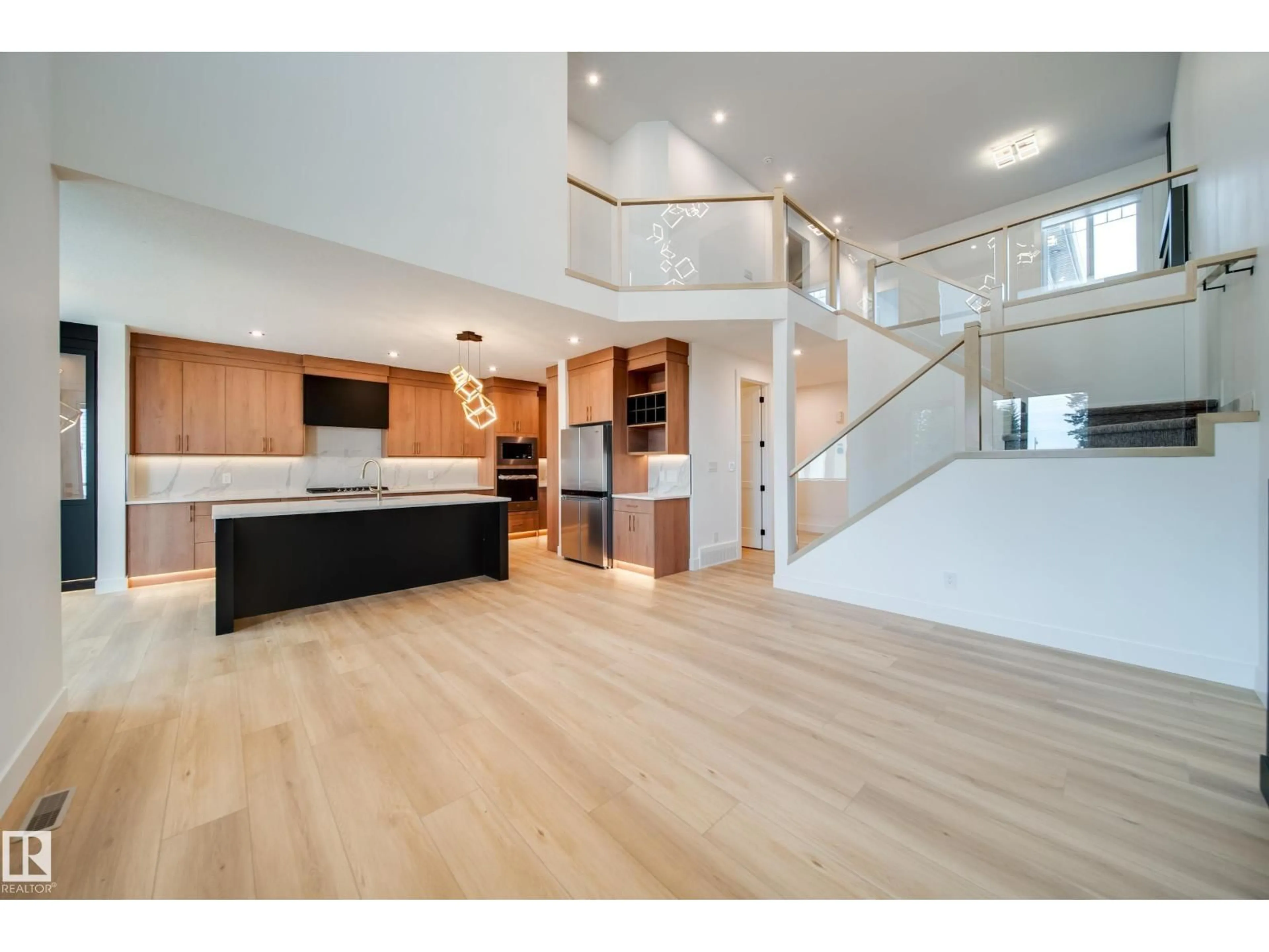 Open concept kitchen, wood/laminate floor for 101 STARLING WY, Fort Saskatchewan Alberta T8L1R5