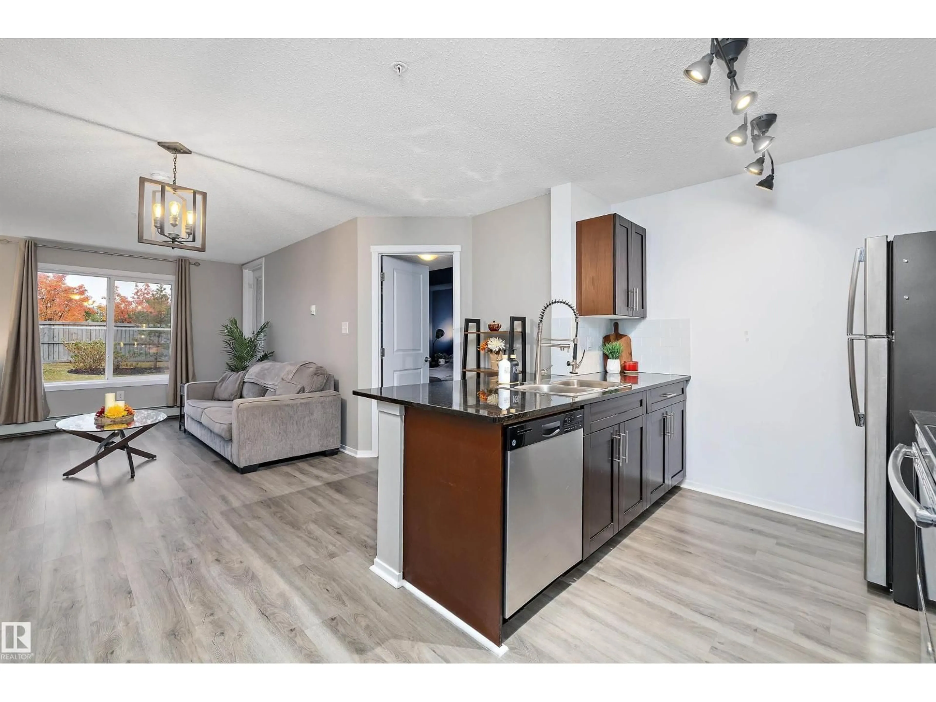 Open concept kitchen, wood/laminate floor for #116 - 18126 77 ST, Edmonton Alberta T5Z0N7