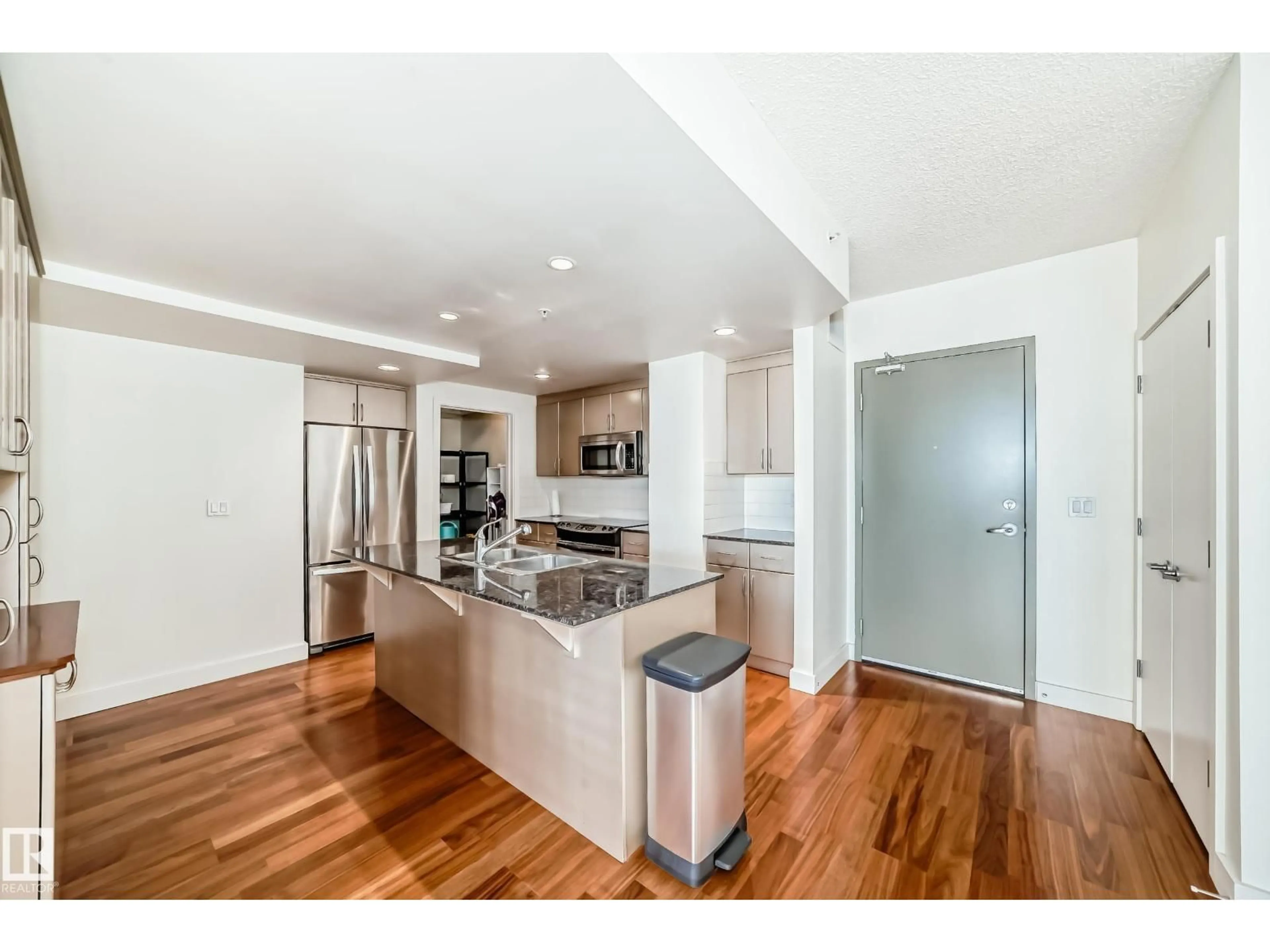 Open concept kitchen, wood/laminate floor for #703 - 10028 119 ST, Edmonton Alberta T5K1Y8
