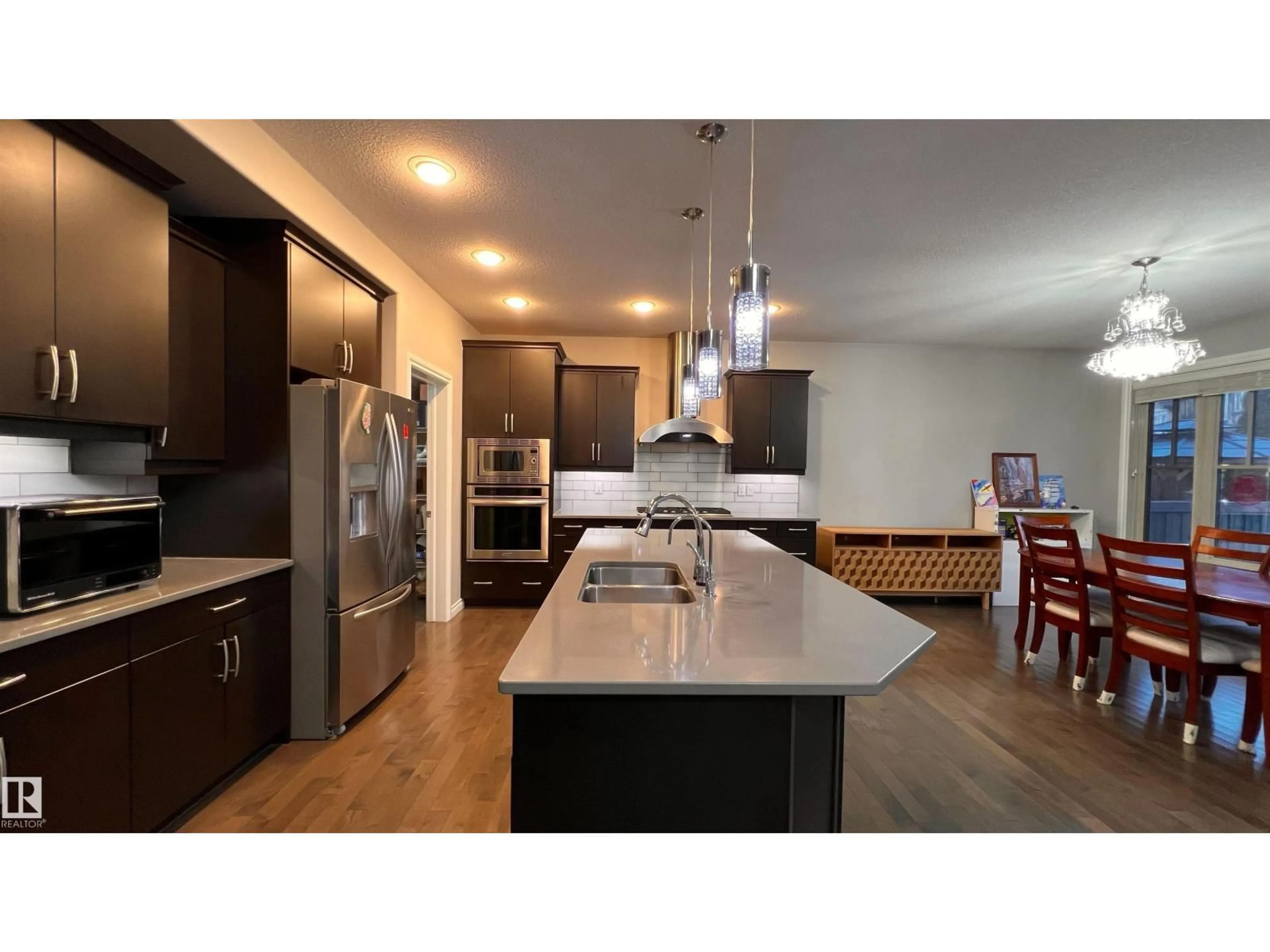 Open concept kitchen, wood/laminate floor for 1076 ARMITAGE CR, Edmonton Alberta T6W0K3