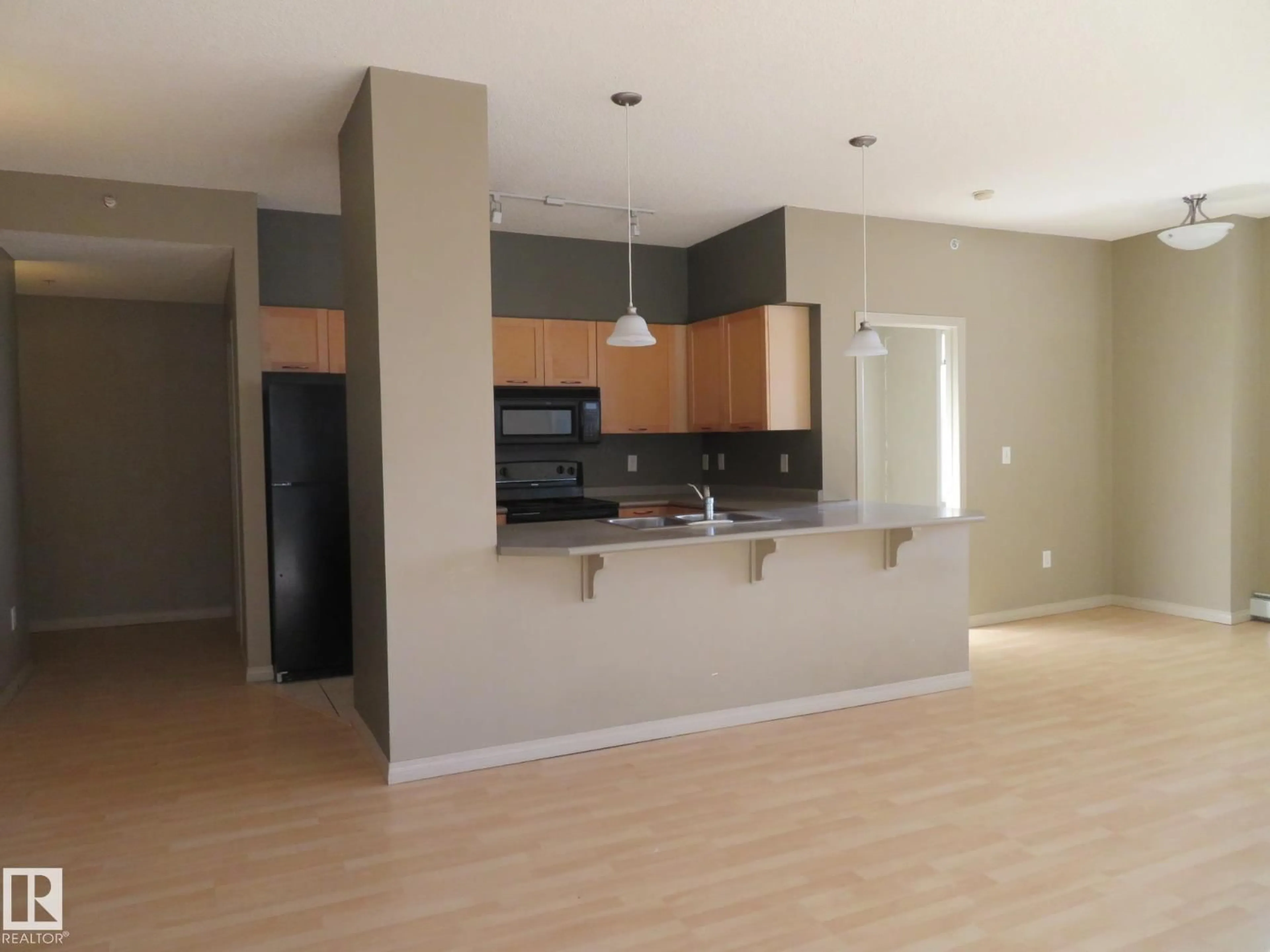 Open concept kitchen, wood/laminate floor for #2-417 - 4245 139 AV, Edmonton Alberta T5Y3E8