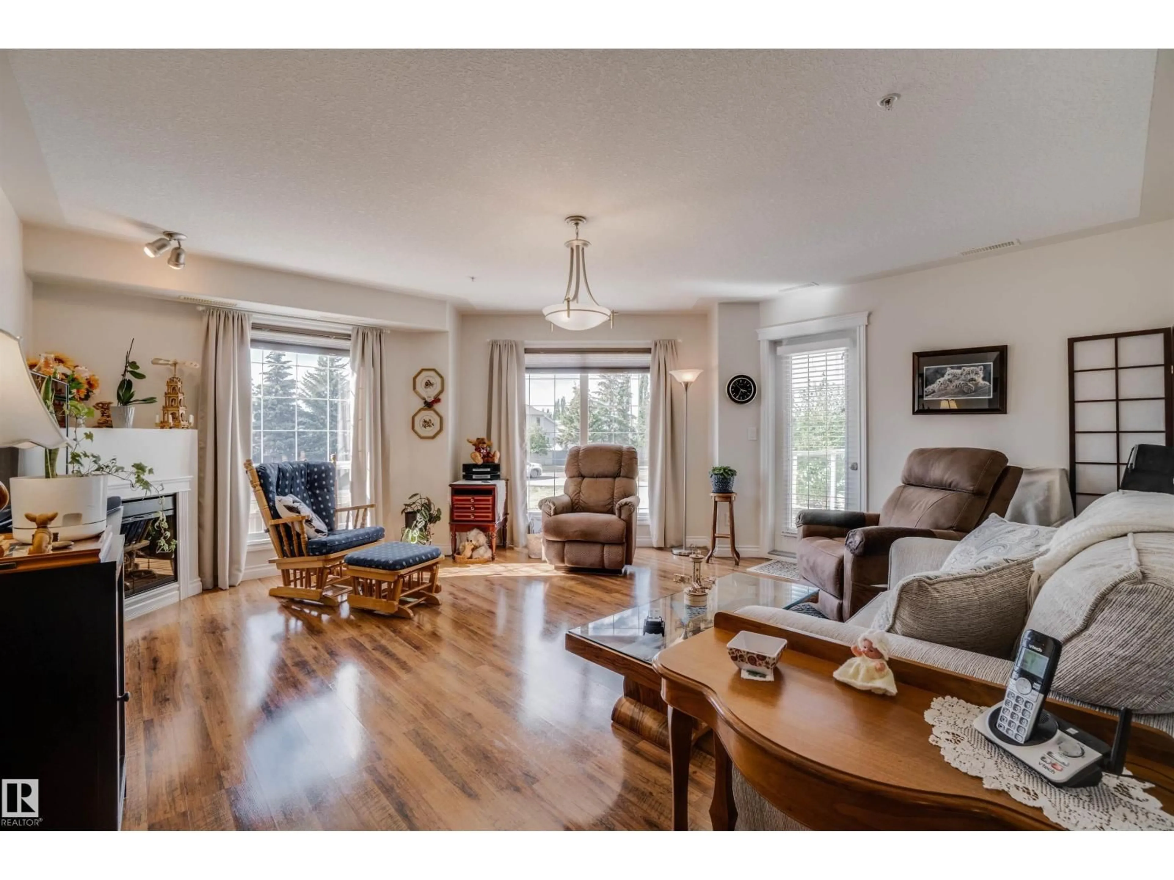 Living room with furniture, wood/laminate floor for #219 - 7801 GOLF COURSE RD, Stony Plain Alberta T7Z0C7