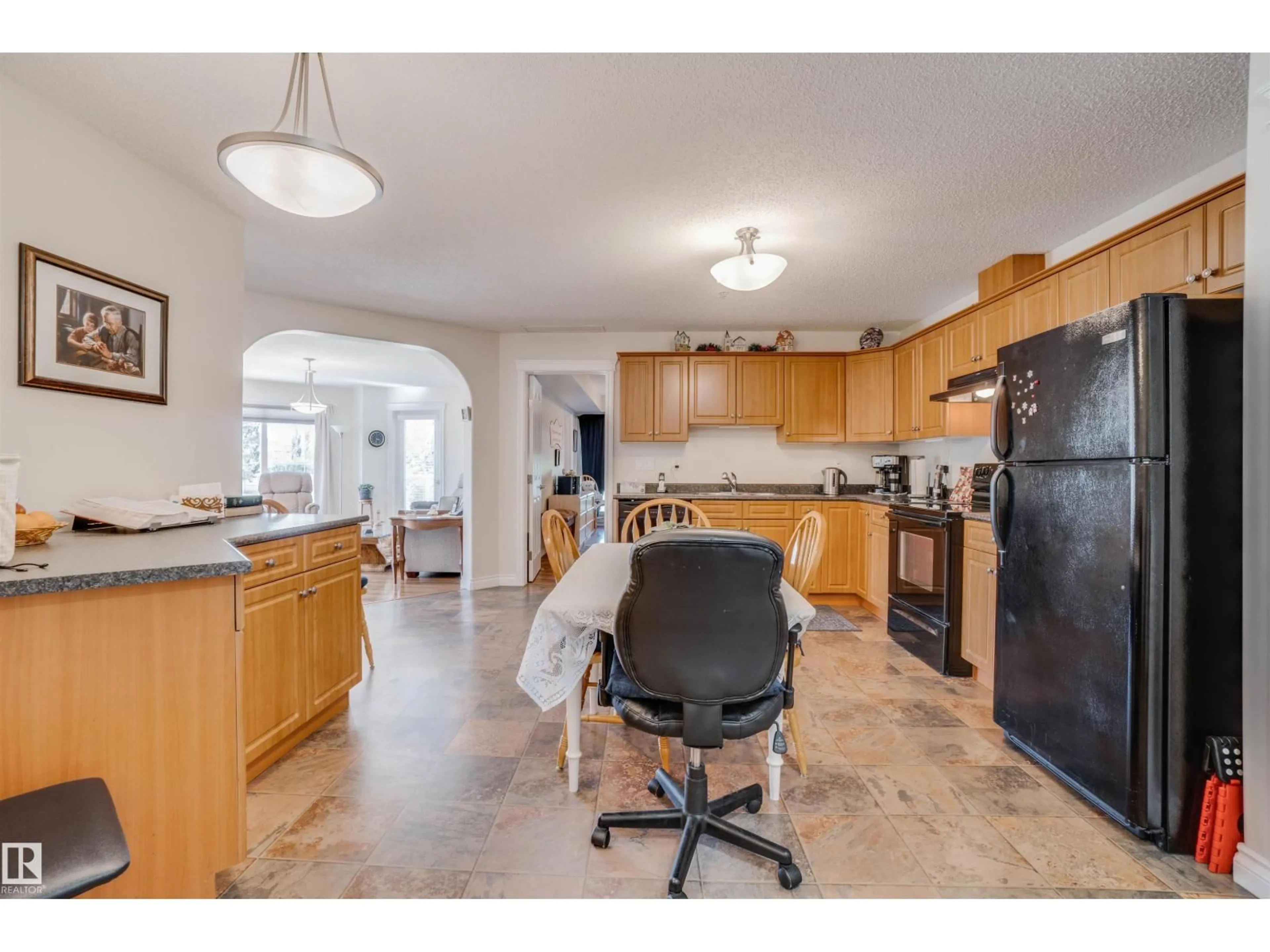 Open concept kitchen, ceramic/tile floor for #219 - 7801 GOLF COURSE RD, Stony Plain Alberta T7Z0C7