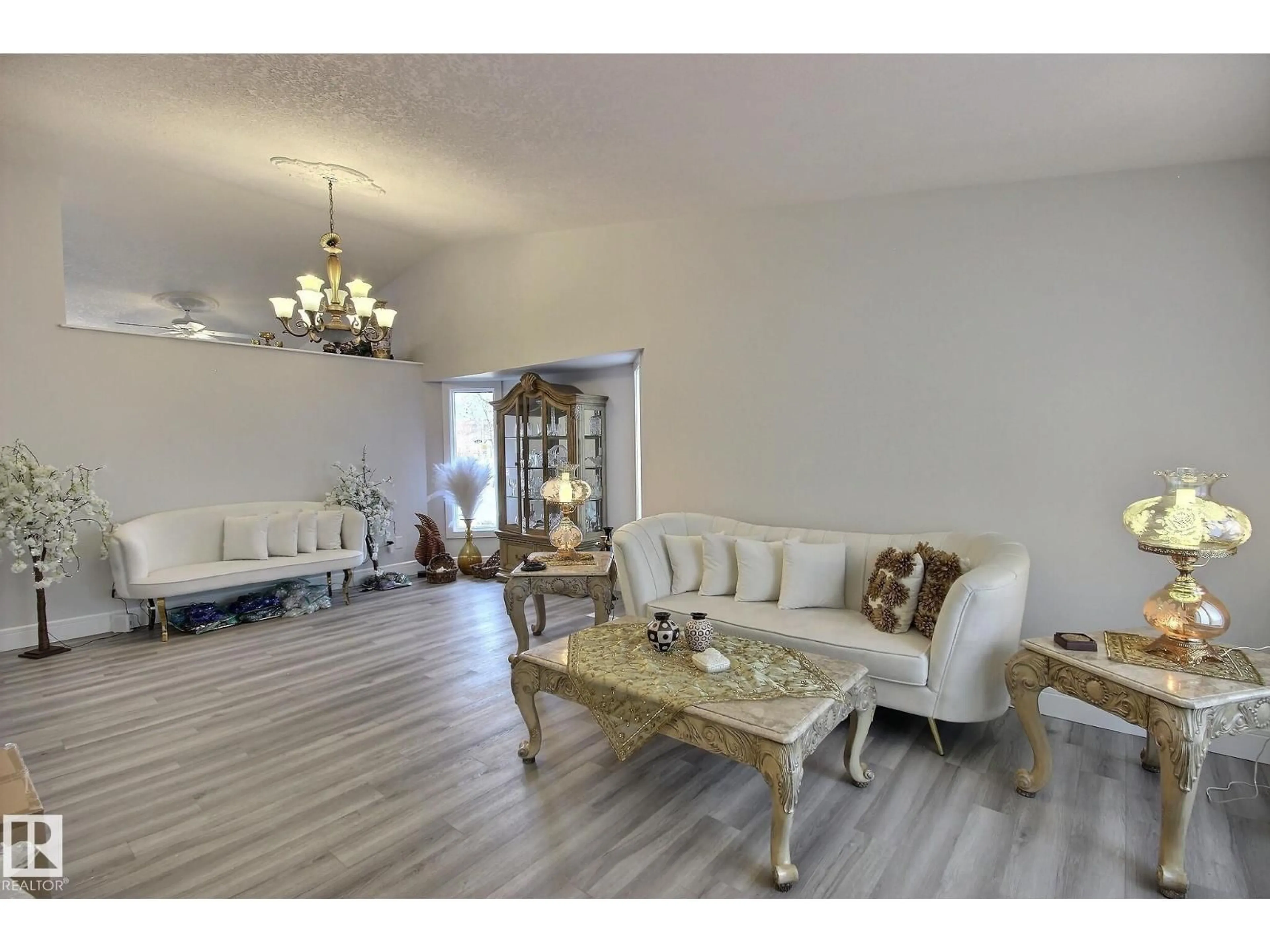 Living room with furniture, wood/laminate floor for 10735 BEAUMARIS RD, Edmonton Alberta T5X5P1