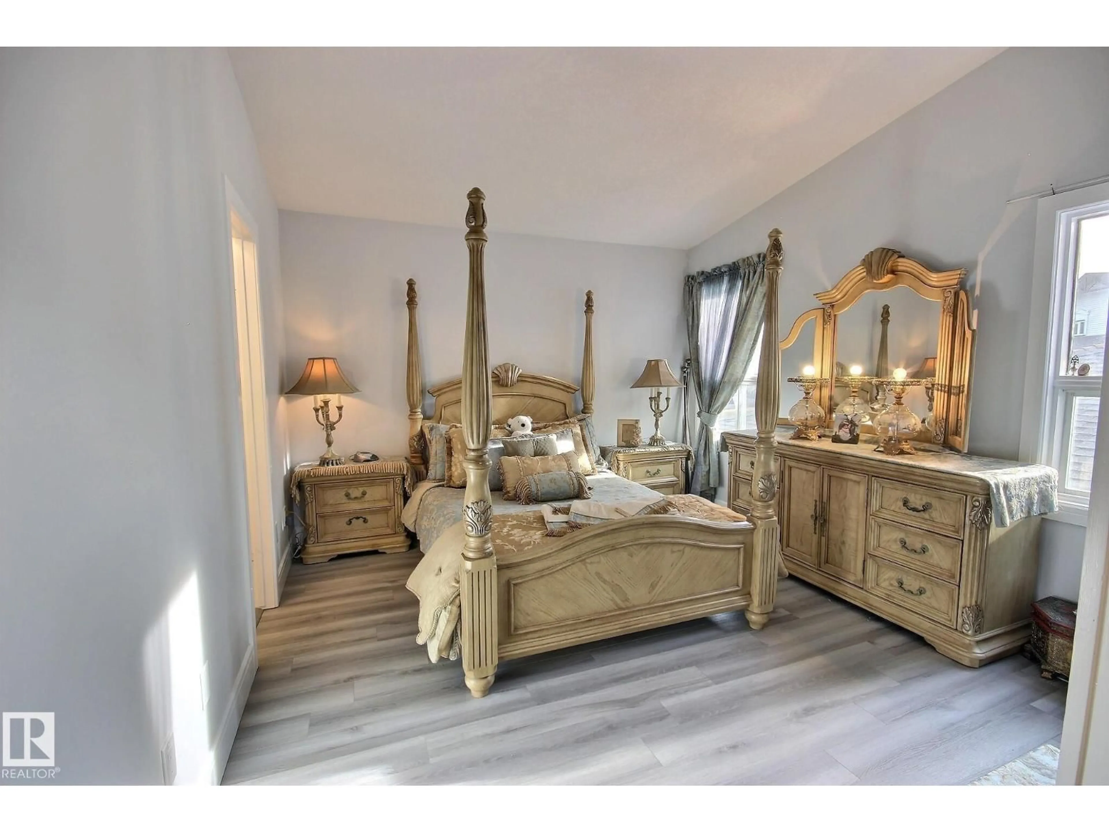 Bedroom with bed, wood/laminate floor for 10735 BEAUMARIS RD, Edmonton Alberta T5X5P1