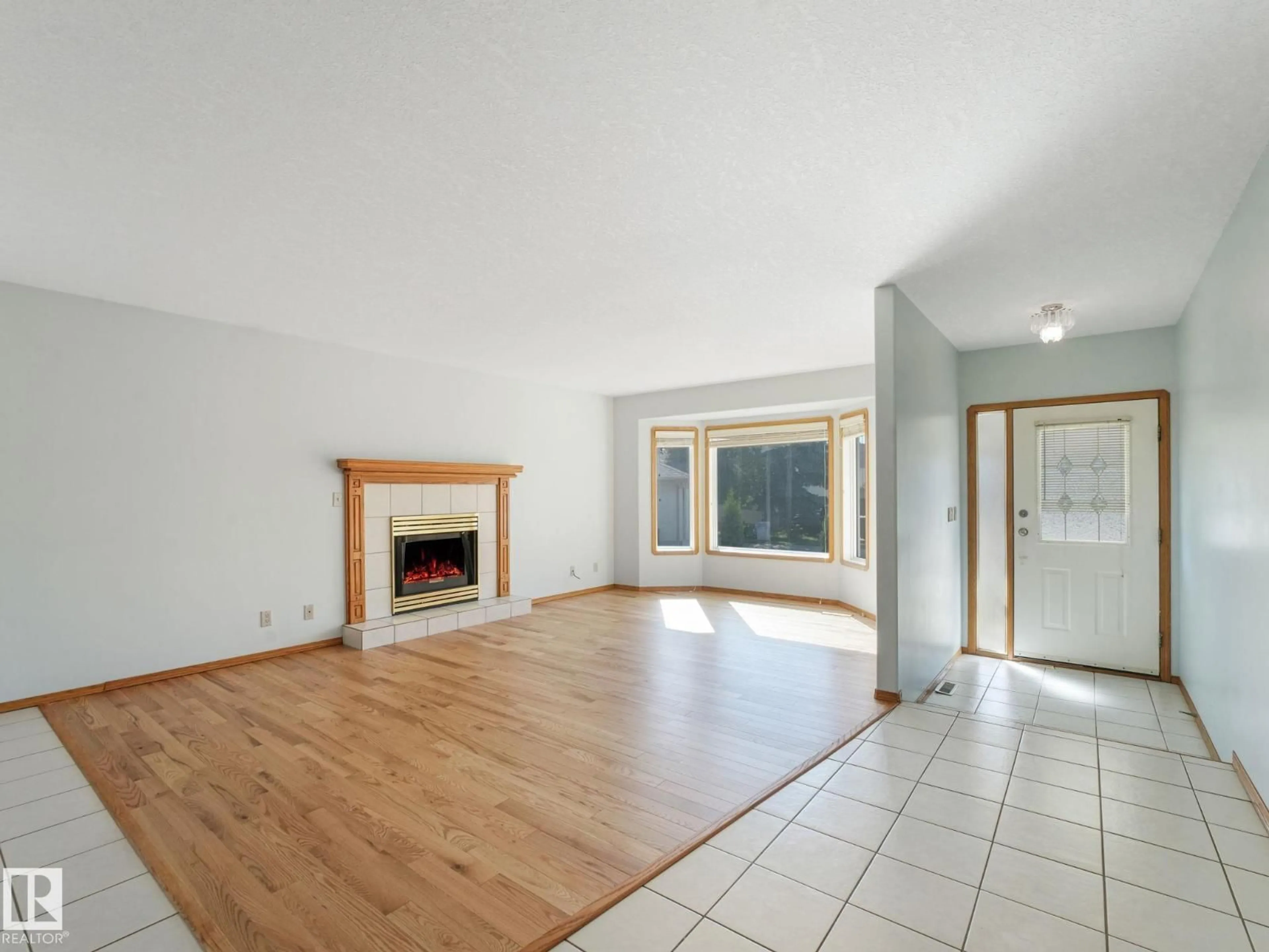Living room with furniture, wood/laminate floor for 1016 JAMES CR, Edmonton Alberta T6L6P6