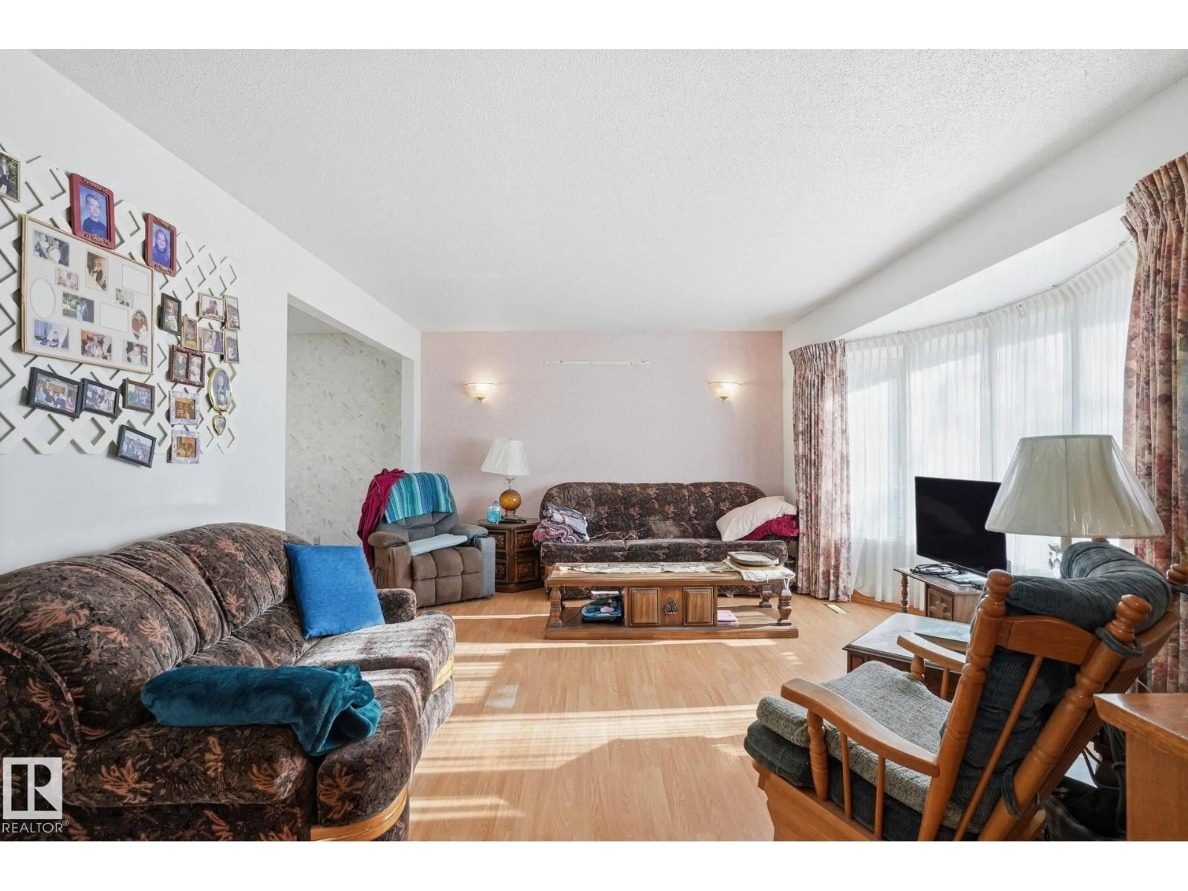 Living room with furniture, wood/laminate floor for 5802 42 AVE, Camrose Alberta T4V2S1