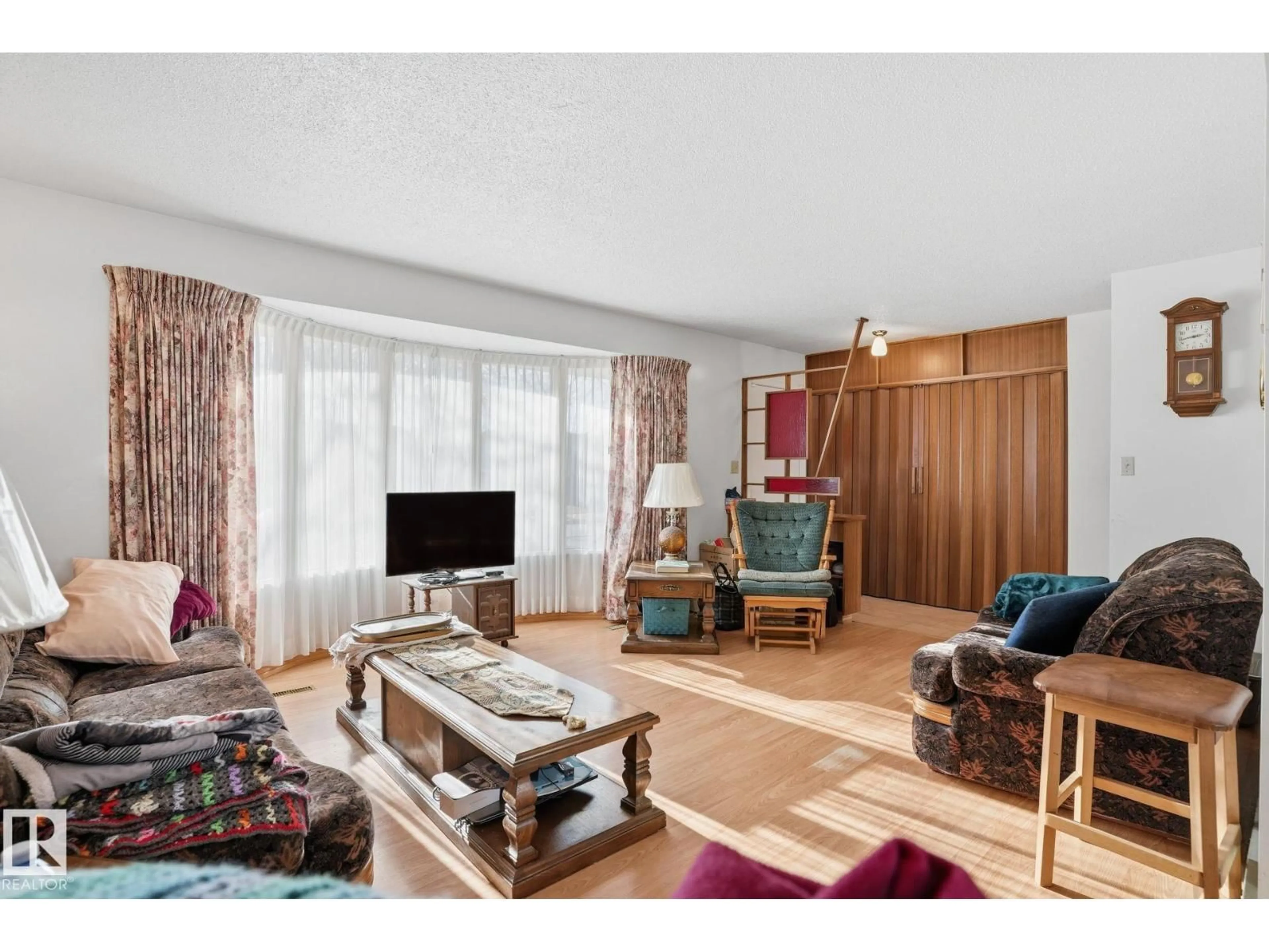 Living room with furniture, wood/laminate floor for 5802 42 AVE, Camrose Alberta T4V2S1