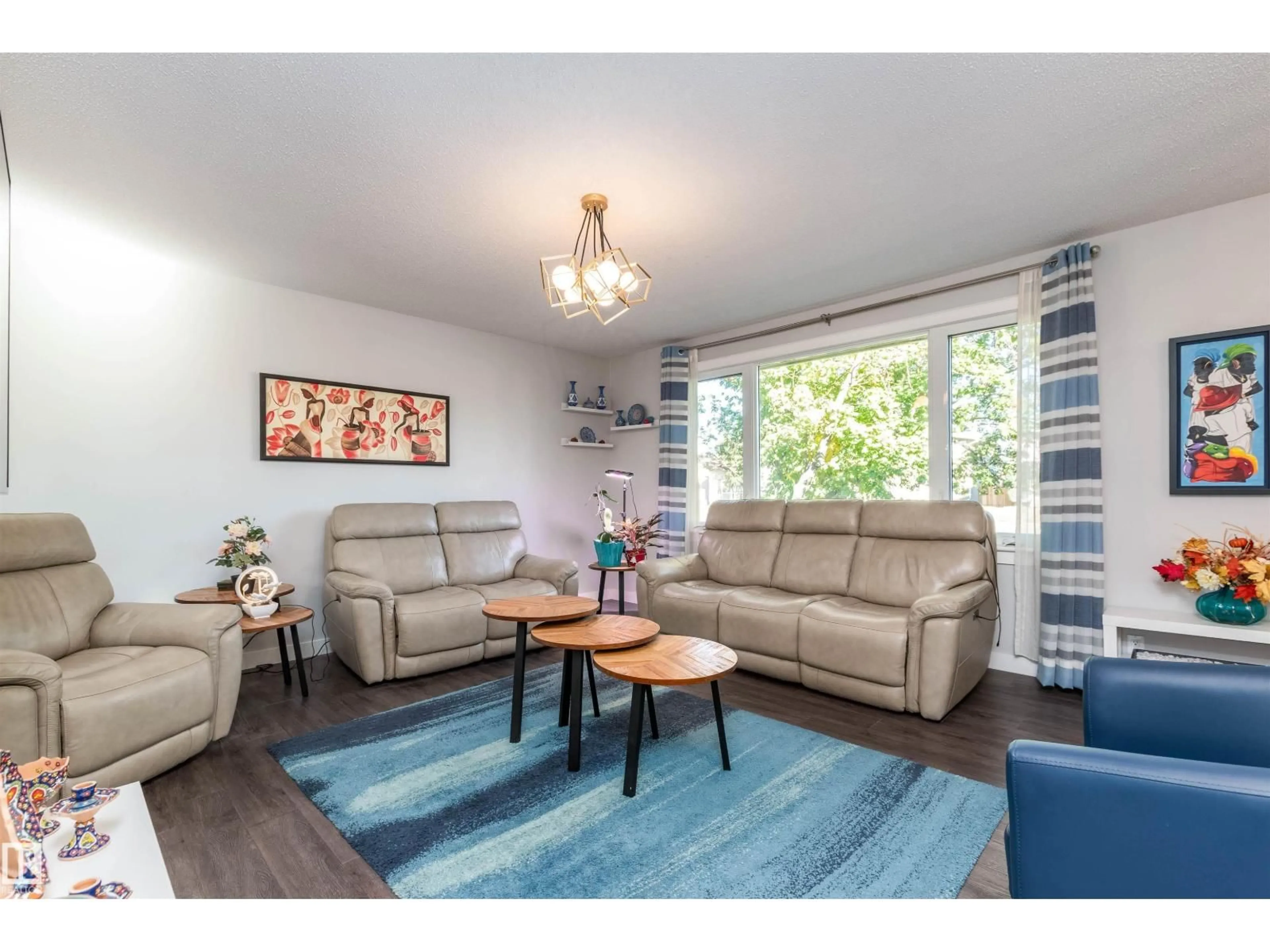 Living room with furniture, wood/laminate floor for NW - 11227 40 AV, Edmonton Alberta T6J0P9