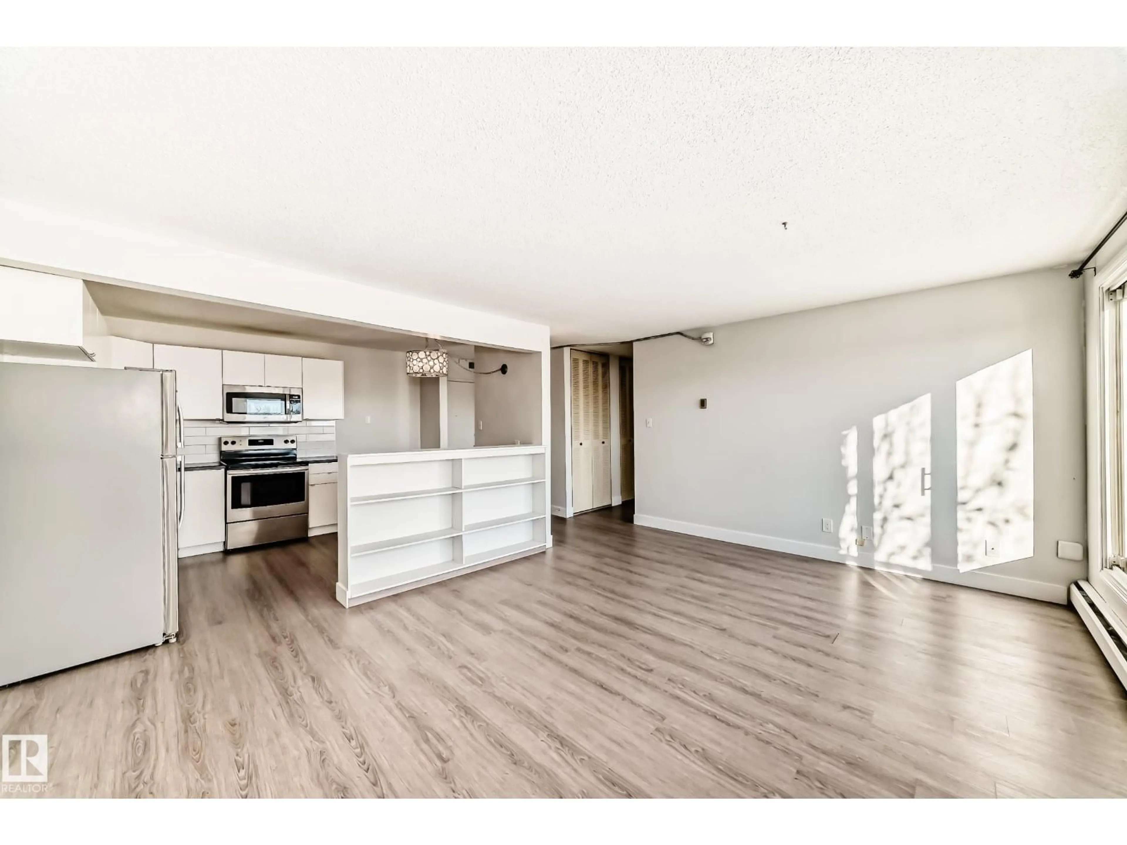 Open concept kitchen, wood/laminate floor for #417 - 8604 GATEWAY BV, Edmonton Alberta T6E4B6