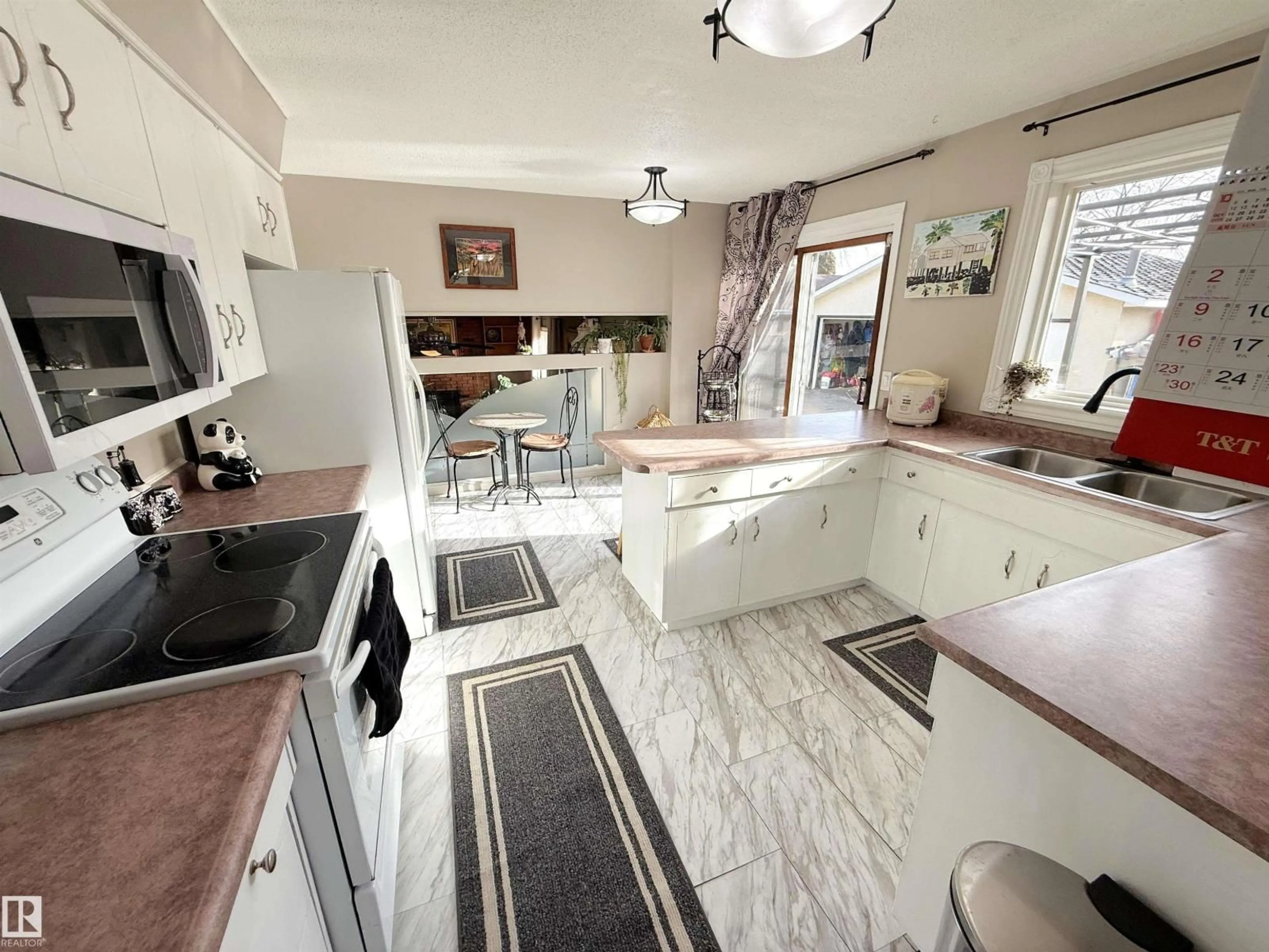 Open concept kitchen, ceramic/tile floor for 3717 136A AV, Edmonton Alberta T5A2P2