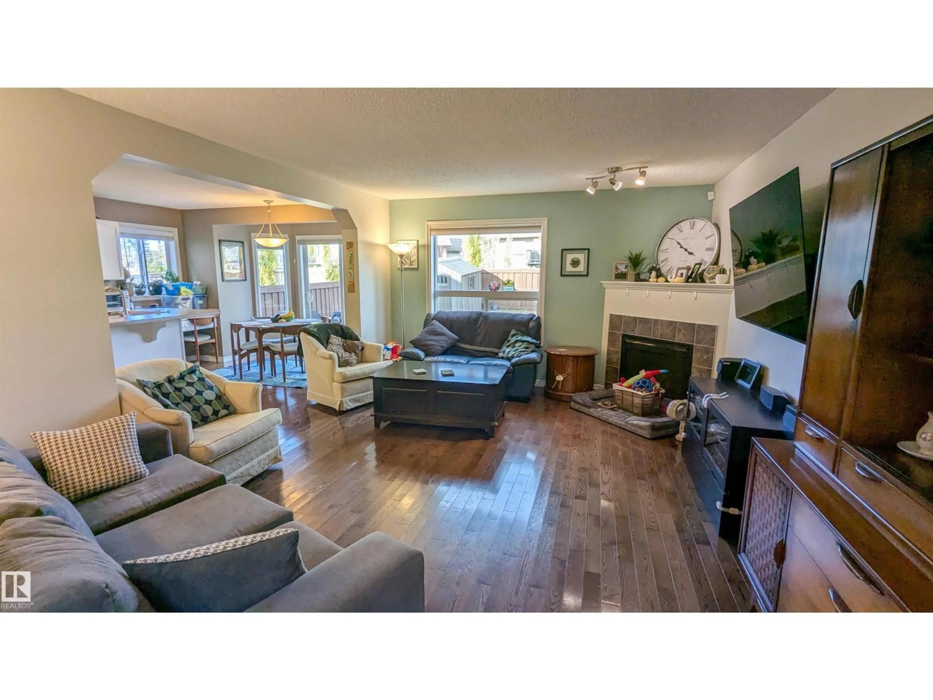 Living room with furniture, wood/laminate floor for 7424 SINGER LANDING LD, Edmonton Alberta T6R3S2