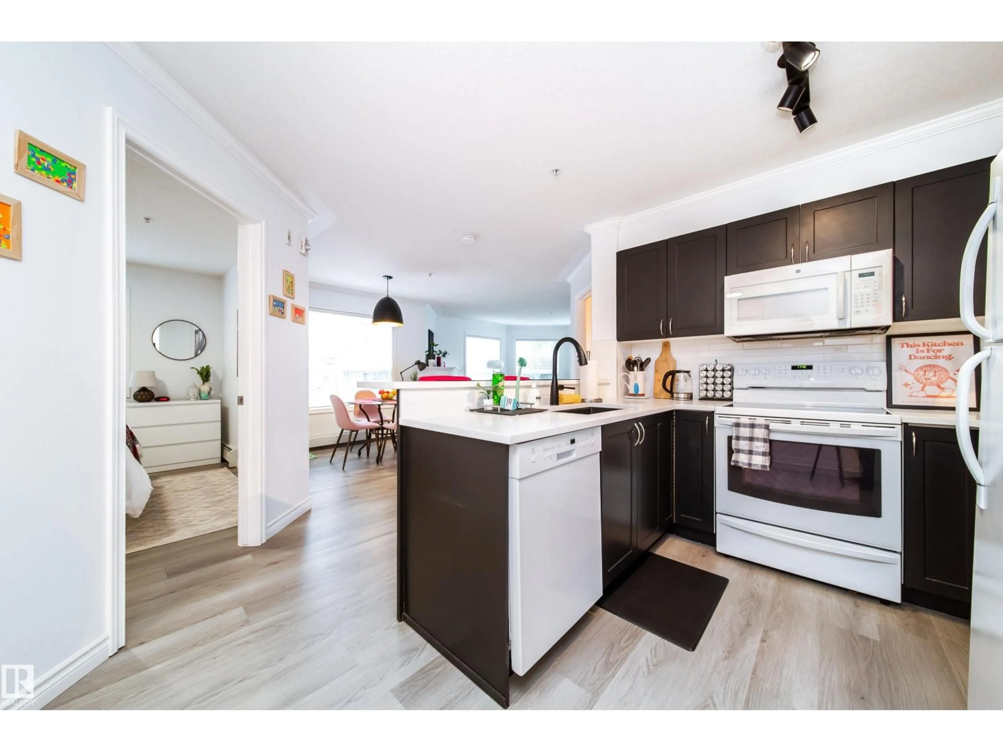 Open concept kitchen, wood/laminate floor for #303 - 9938 104 ST, Edmonton Alberta T5K2X7